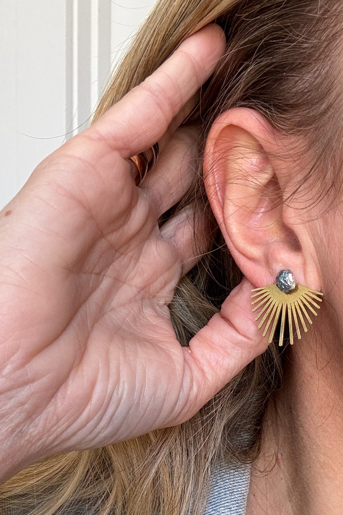 The Hillhurst Layered Studs feature a Bismuth stone with a raw brass burst that can be worn in front of or behind your earlobe. Make a statement with these ethically sourced earrings that were made in the USA.