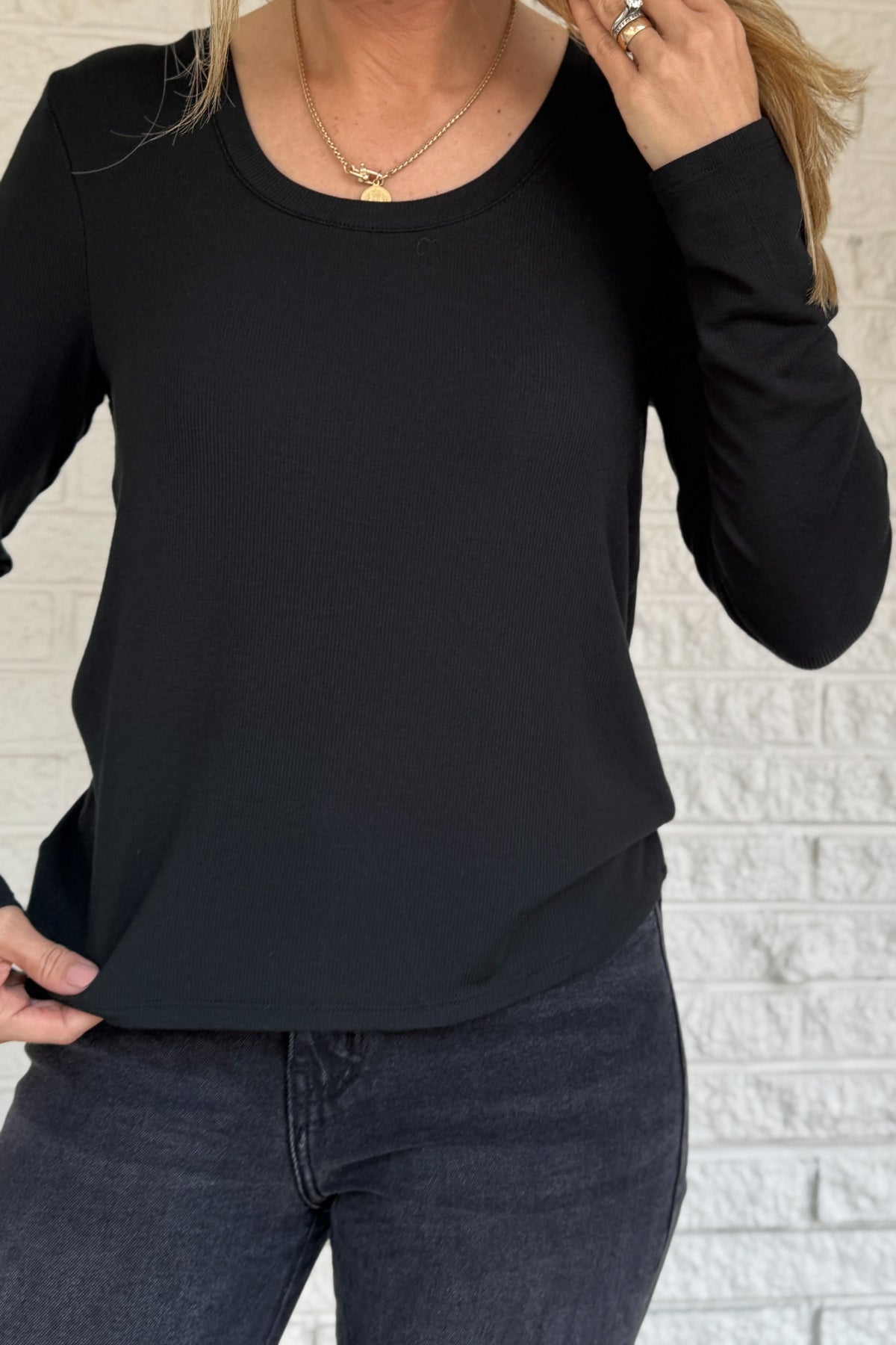 Sleek, soft, and effortlessly classic, this black long sleeve top is a true wardrobe essential. Crafted from silky micro modal with a hint of stretch, it offers a flattering drape and all-day comfort. Perfect for layering or wearing on its own with denim or trousers.