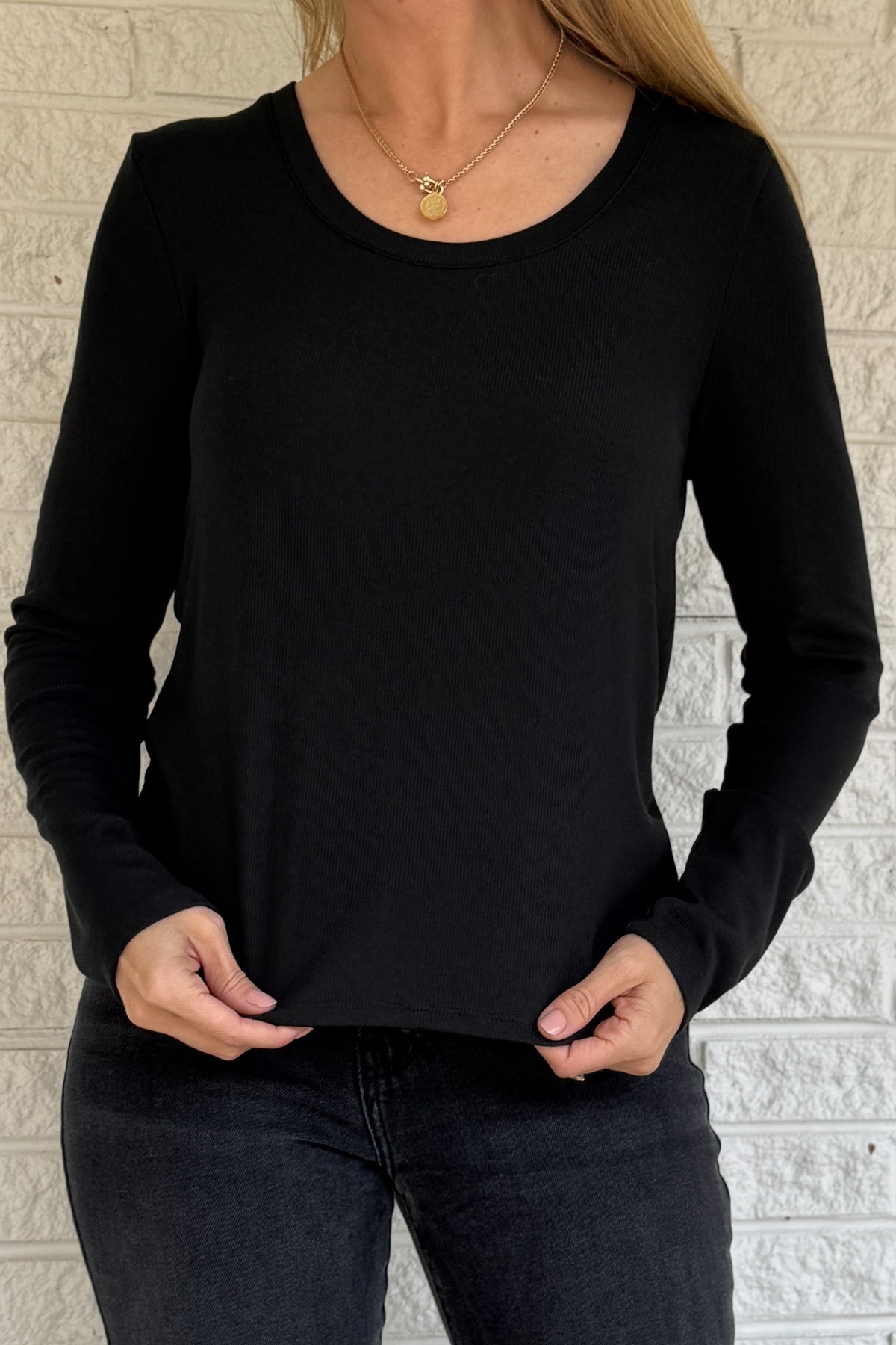 Sleek, soft, and effortlessly classic, this black long sleeve top is a true wardrobe essential. Crafted from silky micro modal with a hint of stretch, it offers a flattering drape and all-day comfort. Perfect for layering or wearing on its own with denim or trousers.