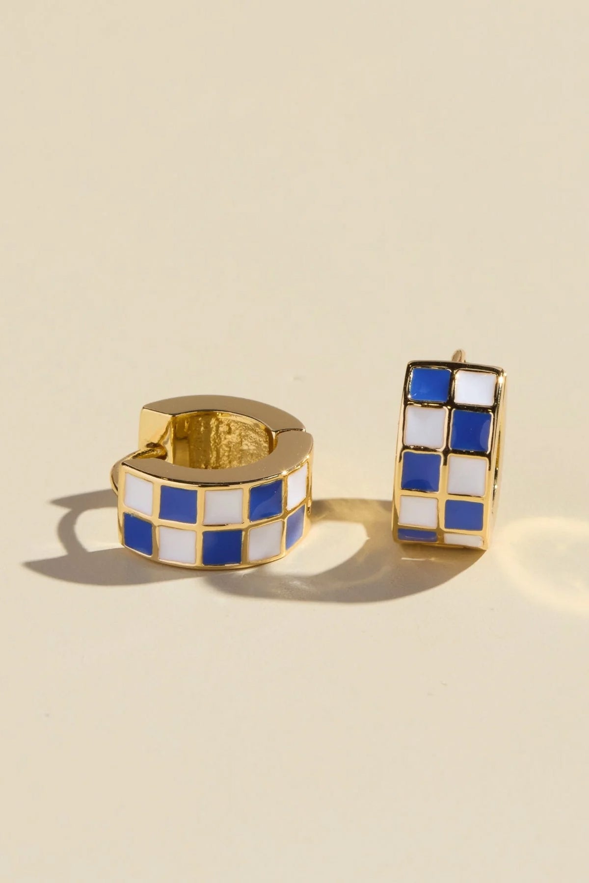 blue enamel huggie earrings, checkered hoop earrings, blue and white earrings, gold huggie earrings, small hoop earrings, enamel earrings, 14k gold plated earrings, titanium post earrings, nickel free earrings, women’s fashion jewelry, boutique earrings, playful everyday earrings, modern hoop earrings, effortless style accessories, Cotton & Cashmere boutique, Blanco Texas boutique, women’s jewelry online, trendy huggie earrings