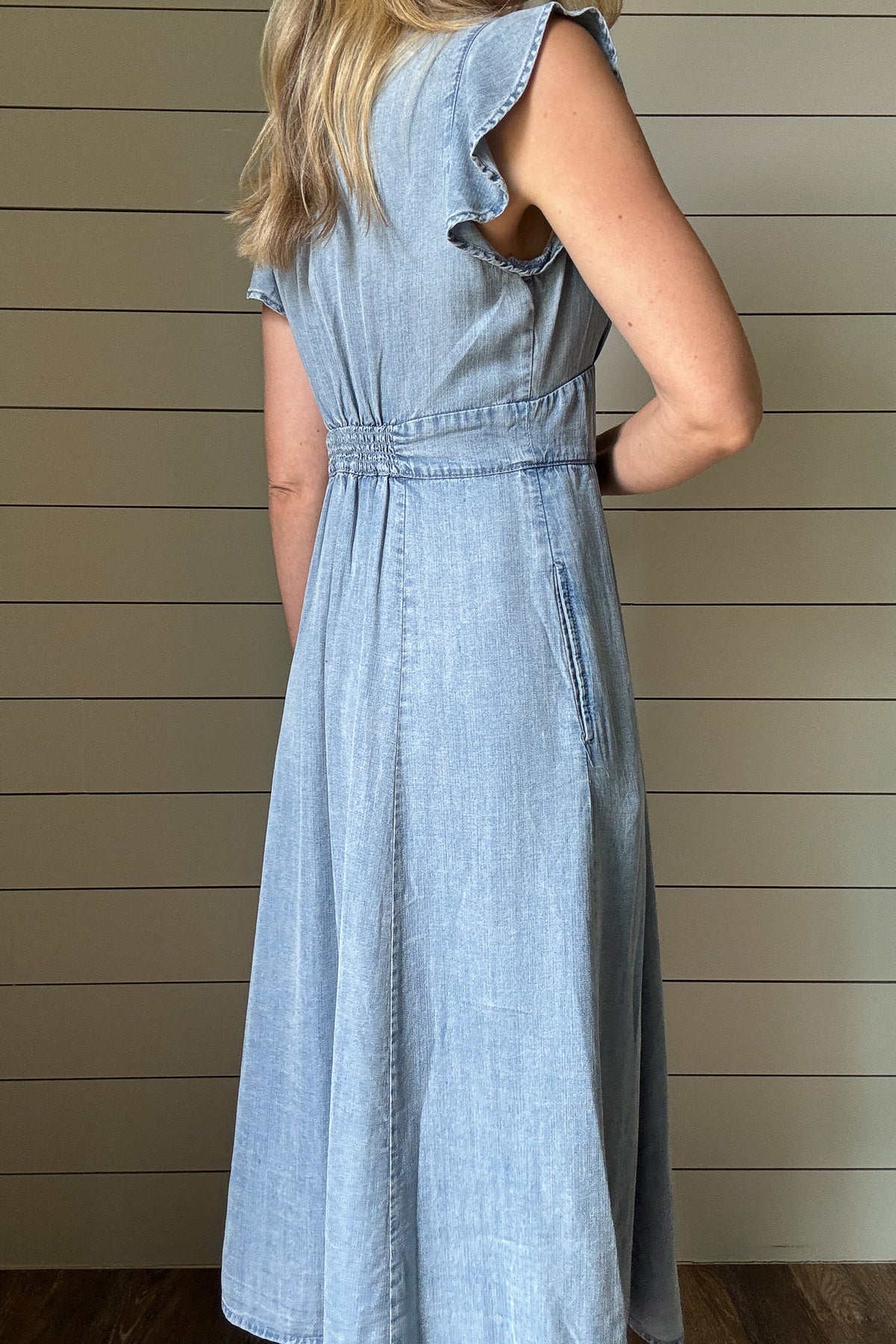 Soft, simple, and so flattering—this Tencel midi dress is an everyday favorite. Lightweight and breathable with a gentle drape, it features true functioning buttons down the front and a subtle V-neckline secured by a hidden eye-hook closure. Flutter sleeves add a feminine touch, while the elastic gathering in the back gives just the right amount of shape and stretch. It’s easy to move in, easy to style, and easy to love. Pair with sandals now and a denim jacket later.
