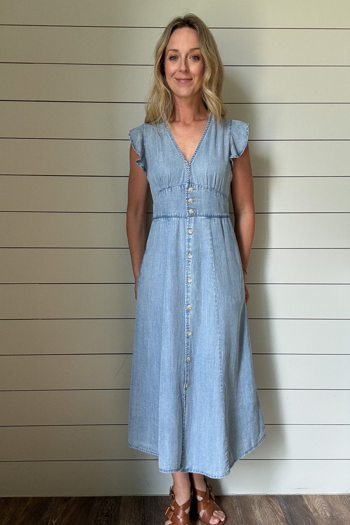 Soft, simple, and so flattering—this Tencel midi dress is an everyday favorite. Lightweight and breathable with a gentle drape, it features true functioning buttons down the front and a subtle V-neckline secured by a hidden eye-hook closure. Flutter sleeves add a feminine touch, while the elastic gathering in the back gives just the right amount of shape and stretch. It’s easy to move in, easy to style, and easy to love. Pair with sandals now and a denim jacket later.