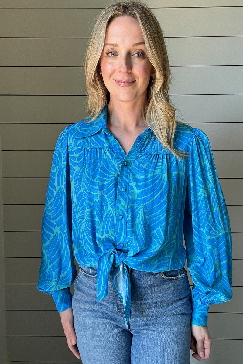 Elevate your wardrobe with our Luna Blouse in Blue.

The striking color palette and unique tie waist design make this blouse a statement piece.

Impeccable detailing and a banded back allow for a flattering billowing effect. Take your style to the next level with this luxurious and sophisticated top.