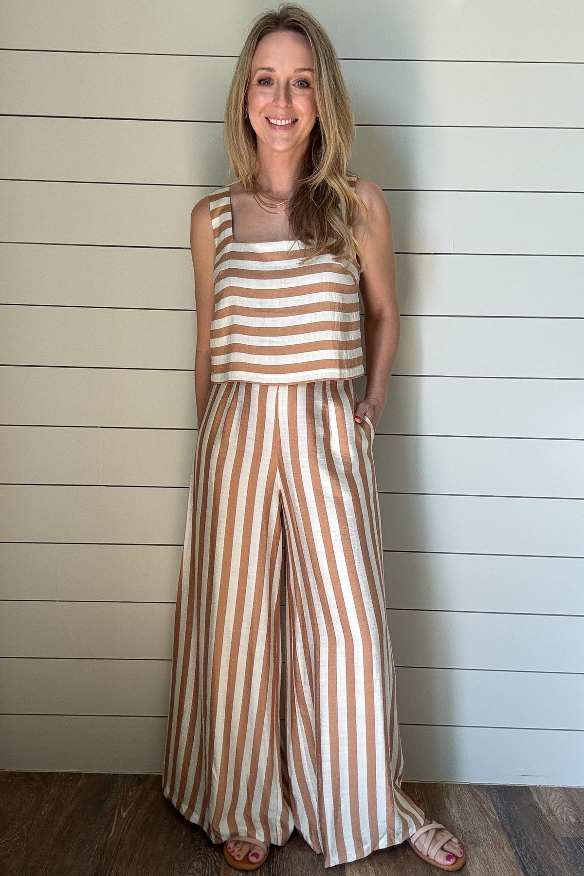 Effortless, breezy, and oh so fun! These full-length billowy pants from Traffic People bring all the flow with their vertical tan and cream stripes, side zipper, flattering flat front waistband, and comfy elastic back. They’ve got pockets (because who doesn’t love pockets?) and a soft lining for easy wear.

They pair with the striped shell top for a playful twist—horizontal stripes, a sleek square neckline, and a slip on design make it the perfect match. A little boho, a little classic, and totally effortle