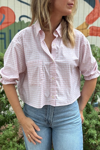 Back photo:
Back view of VonVie Harlow pink gingham cropped shirt with open back and red and navy ribbon ties

Side photo:
Side view of VonVie Harlow pink gingham shirt with puff sleeves, ruffled cuffs, and a relaxed cropped fit
