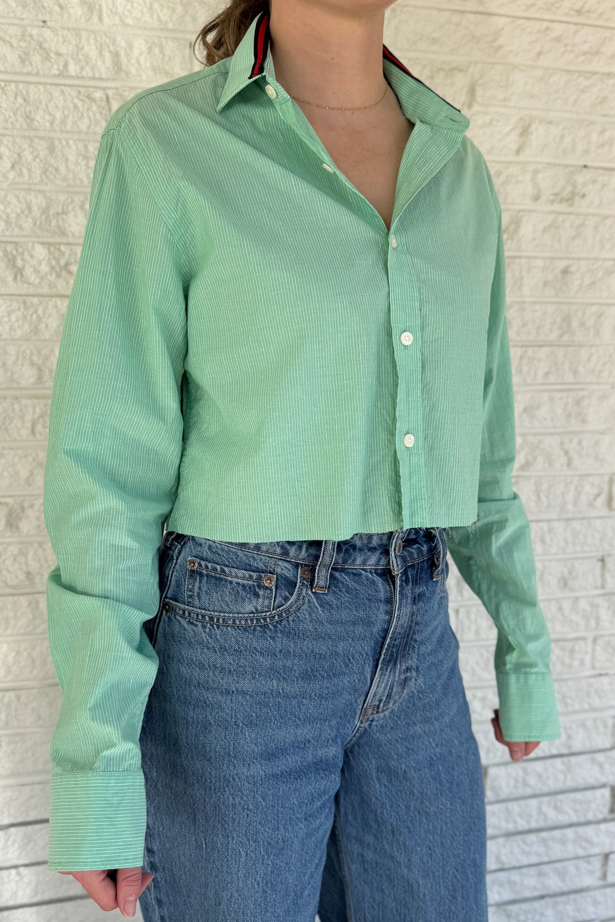 An upcycled men’s shirt reworked into a cropped, raw hem, easy silhouette that feels fresh and relaxed. Soft, feminine, and one-of-a-kind. Designed to be a one size fits most when worn open, wear it buttoned up and it fits like small or medium.