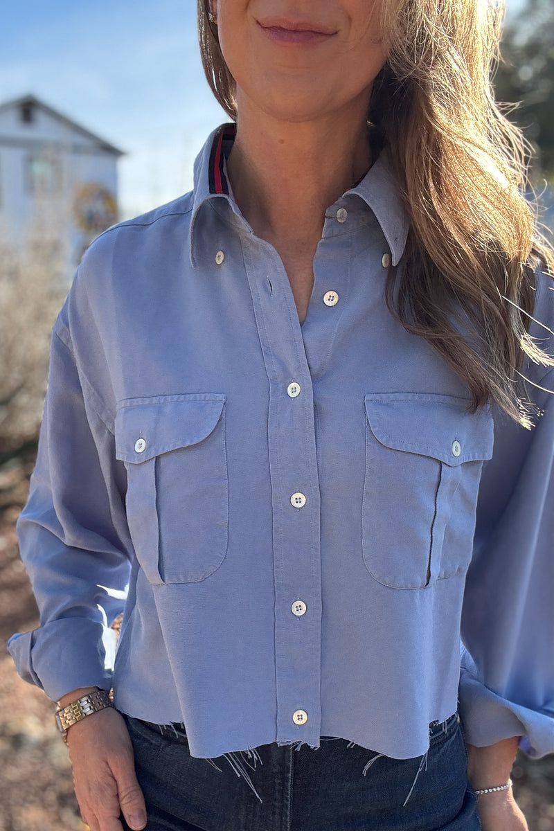 An upcycled men’s shirt reworked into a cropped, raw hem, easy silhouette that feels fresh and relaxed. Large front pockets add a fun twist to the buttery soft shirt. Soft, breathable, and one-of-a-kind. Designed to be a one size fits most, wear it buttoned up and it fits like an XS or small, wear it open and it fits size medium or large. Women's fashion boutique Blanco Texas