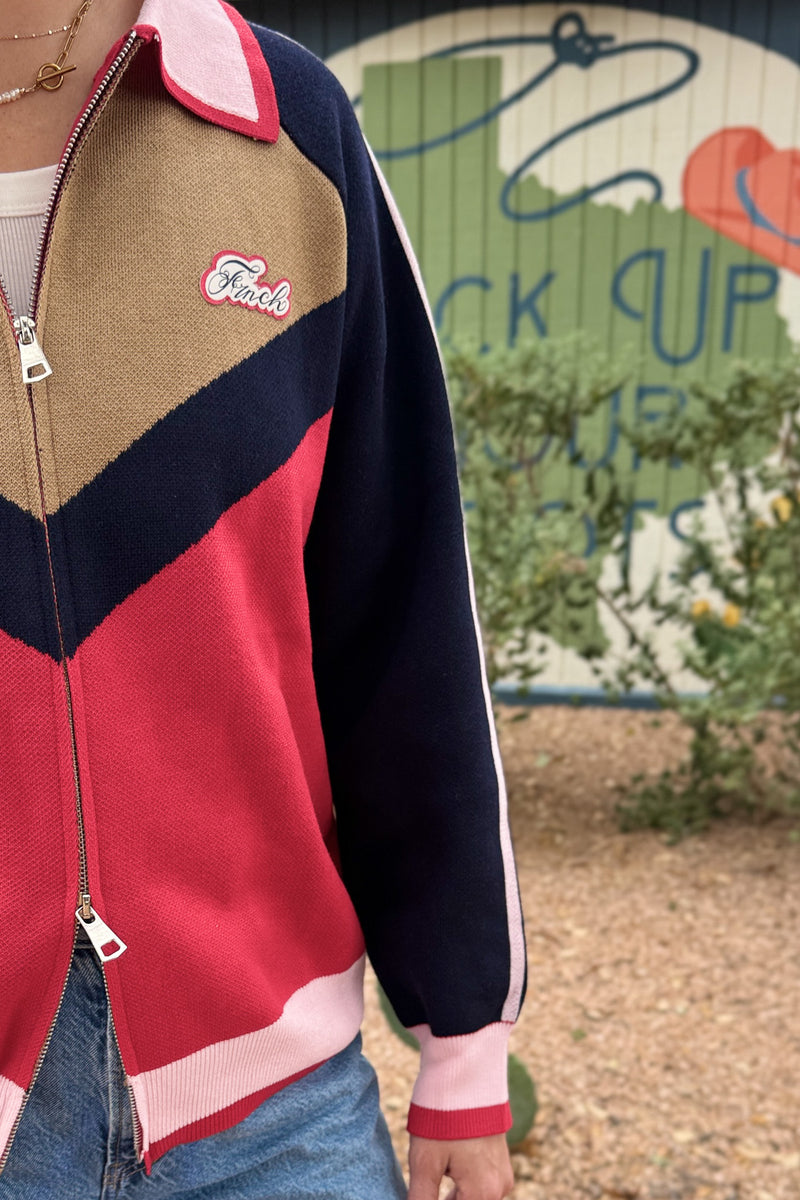close up of FRNCH women’s colorblock zip sweater cardigan in red, navy, camel and pink at Cotton & Cashmere boutique in Blanco, Texas