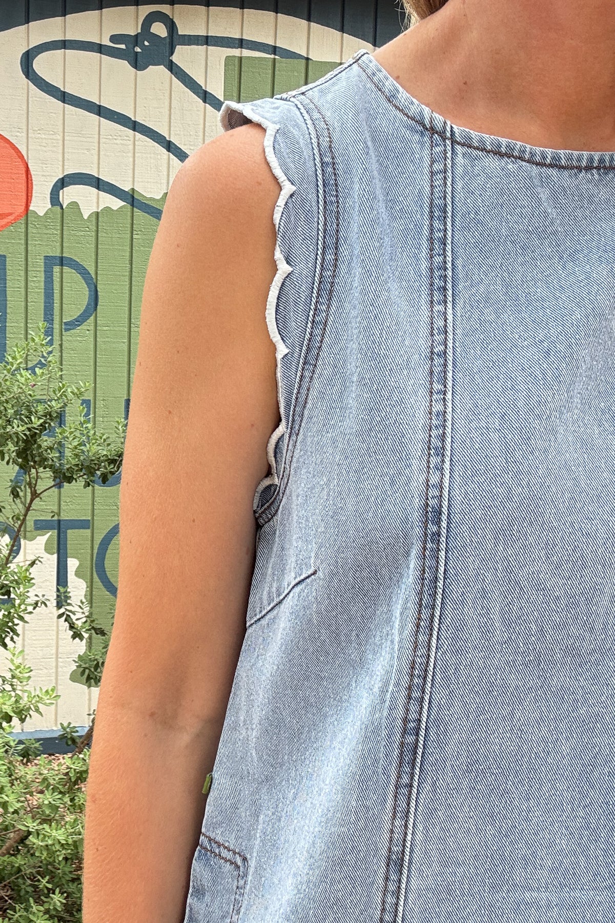 FRNCH 100% cotton denim dress with scalloped shoulder details, side pockets, and tie-back detail at Cotton and Cashmere in Blanco Texas

Sleeveless FRNCH denim dress made from 100% cotton with scalloped shoulders, relaxed fit, pockets, and open tie-back detail

Light wash cotton denim dress by FRNCH with scalloped shoulder trim, side pockets, and easy shift-style fit

FRNCH women’s cotton denim dress with feminine scalloped shoulders, tie-back opening, and pockets for effortless everyday style