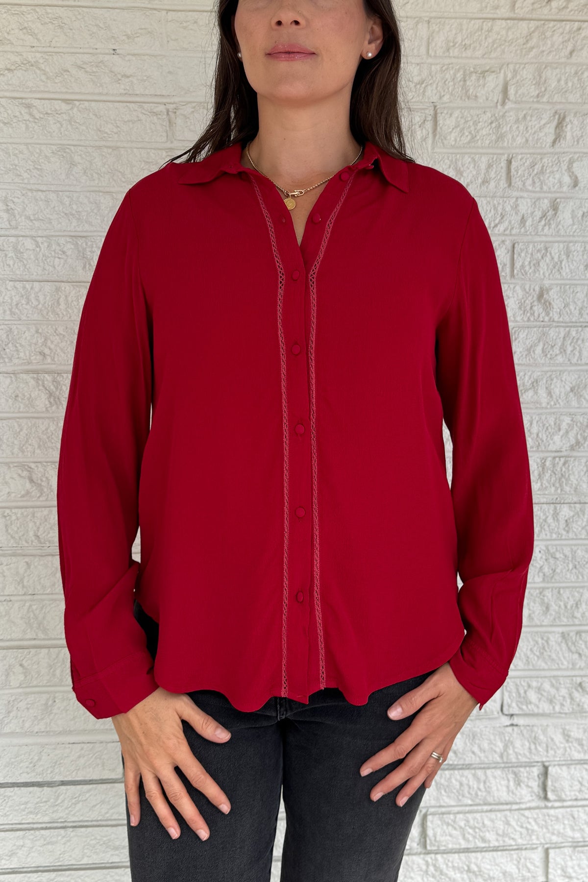&nbsp;This rich red blouse delivers classic style with a subtle feminine touch. Designed in soft 100% viscose, it features delicate lace trim along the button placket and a flattering v-neckline with a small collar.