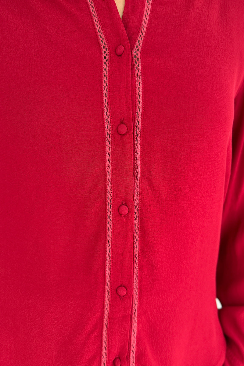 &nbsp;This rich red blouse delivers classic style with a subtle feminine touch. Designed in soft 100% viscose, it features delicate lace trim along the button placket and a flattering v-neckline with a small collar.
