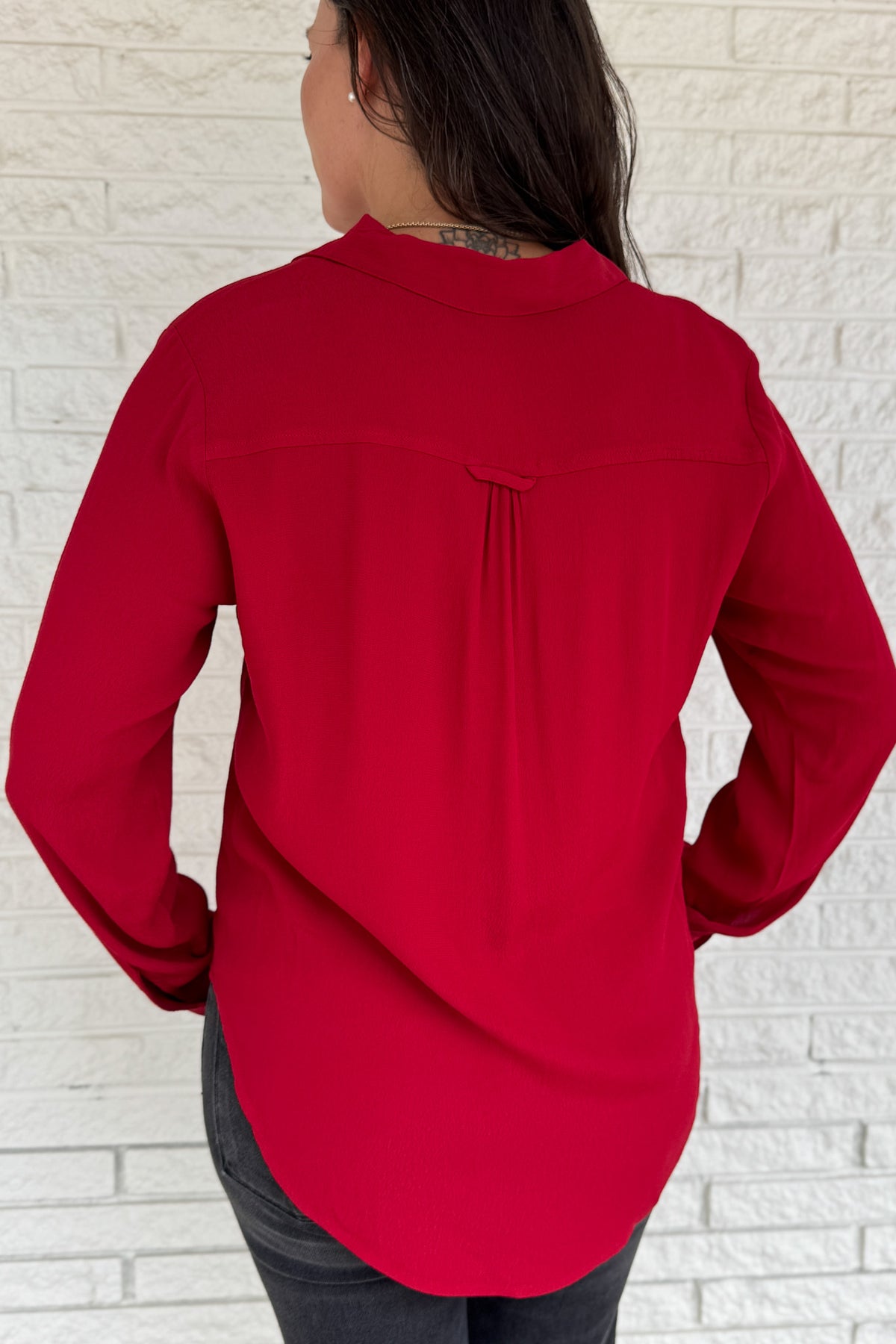 &nbsp;This rich red blouse delivers classic style with a subtle feminine touch. Designed in soft 100% viscose, it features delicate lace trim along the button placket and a flattering v-neckline with a small collar.