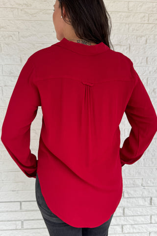 &nbsp;This rich red blouse delivers classic style with a subtle feminine touch. Designed in soft 100% viscose, it features delicate lace trim along the button placket and a flattering v-neckline with a small collar.