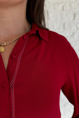 &nbsp;This rich red blouse delivers classic style with a subtle feminine touch. Designed in soft 100% viscose, it features delicate lace trim along the button placket and a flattering v-neckline with a small collar.