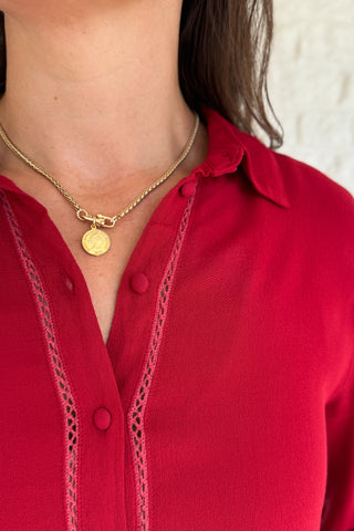 &nbsp;This rich red blouse delivers classic style with a subtle feminine touch. Designed in soft 100% viscose, it features delicate lace trim along the button placket and a flattering v-neckline with a small collar.