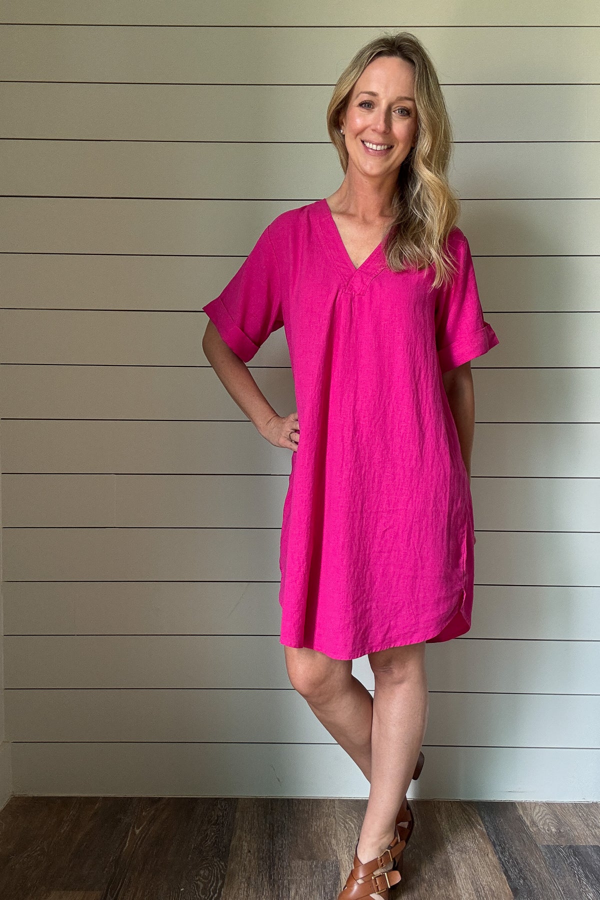 Bright, breezy, and bold—this hot pink shirt dress is your warm-weather staple. Made from a lightweight viscose-linen blend, it gives you that effortless, airy feel without all the wrinkles. The oversized fit keeps things relaxed and comfortable, while the structured collar and button-down front add just enough polish. It hits right at the knee, making it perfect for brunch, travel, or tossing on over a swimsuit. Dress it up with wedges or keep it casual with sneakers. It’s easy, fun, and made to move with 