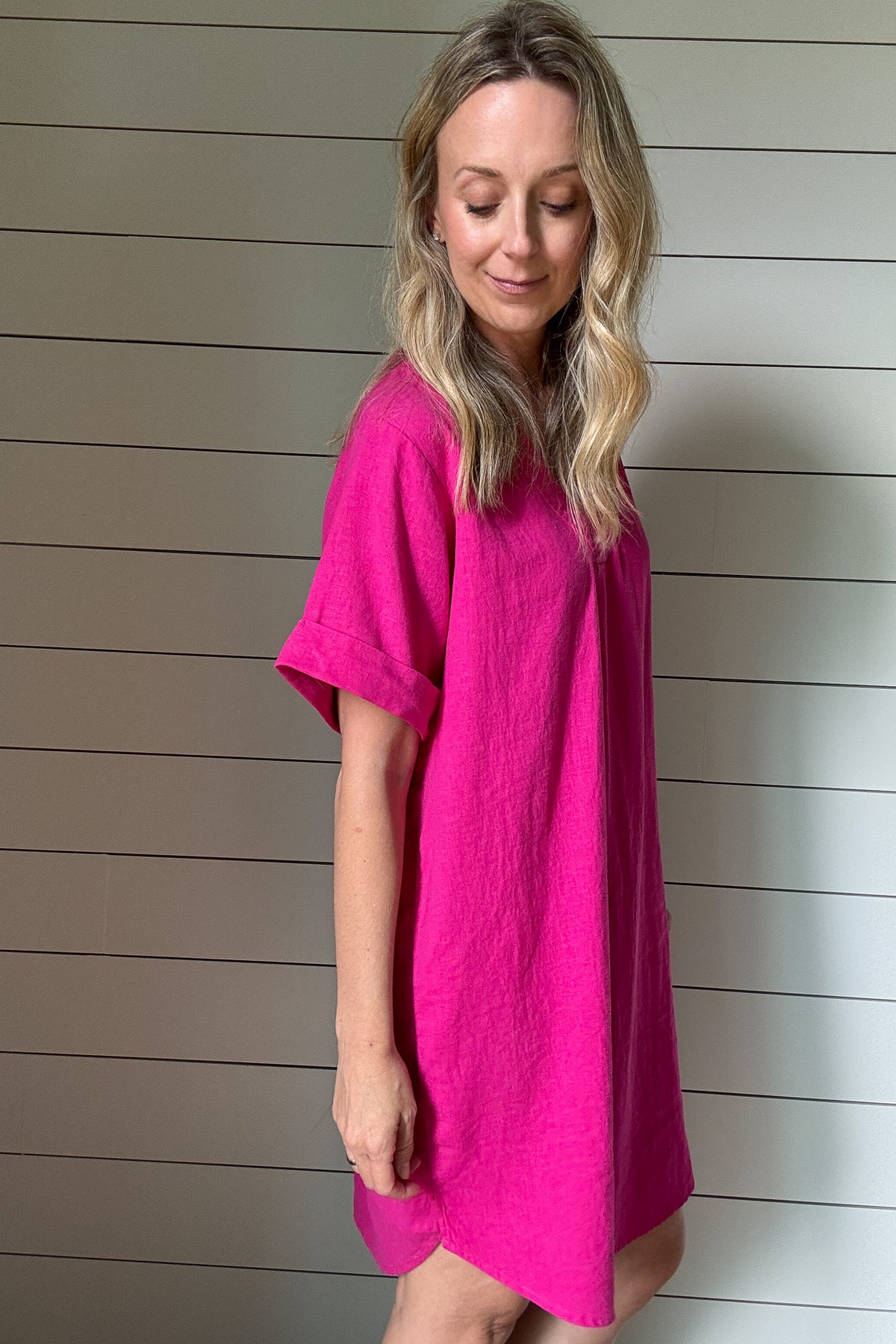 Bright, breezy, and bold—this hot pink shirt dress is your warm-weather staple. Made from a lightweight viscose-linen blend, it gives you that effortless, airy feel without all the wrinkles. The oversized fit keeps things relaxed and comfortable, while the structured collar and button-down front add just enough polish. It hits right at the knee, making it perfect for brunch, travel, or tossing on over a swimsuit. Dress it up with wedges or keep it casual with sneakers. It’s easy, fun, and made to move with 