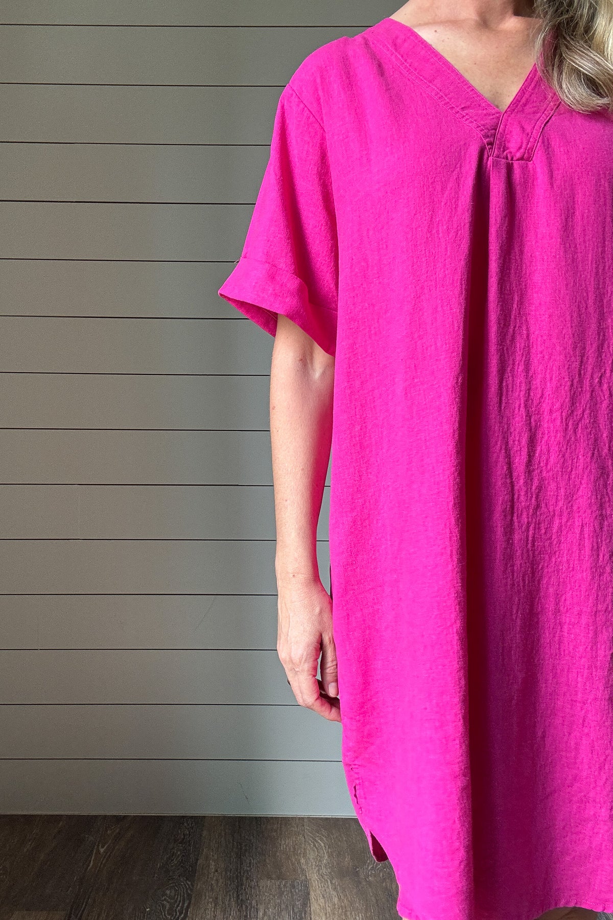 Bright, breezy, and bold—this hot pink shirt dress is your warm-weather staple. Made from a lightweight viscose-linen blend, it gives you that effortless, airy feel without all the wrinkles. The oversized fit keeps things relaxed and comfortable, while the structured collar and button-down front add just enough polish. It hits right at the knee, making it perfect for brunch, travel, or tossing on over a swimsuit. Dress it up with wedges or keep it casual with sneakers. It’s easy, fun, and made to move with 