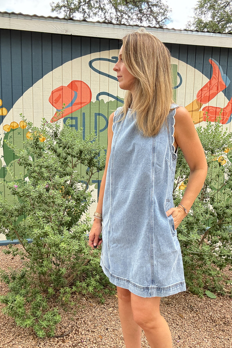 FRNCH 100% cotton denim dress with scalloped shoulder details, side pockets, and tie-back detail at Cotton and Cashmere in Blanco Texas

Sleeveless FRNCH denim dress made from 100% cotton with scalloped shoulders, relaxed fit, pockets, and open tie-back detail

Light wash cotton denim dress by FRNCH with scalloped shoulder trim, side pockets, and easy shift-style fit

FRNCH women’s cotton denim dress with feminine scalloped shoulders, tie-back opening, and pockets for effortless everyday style