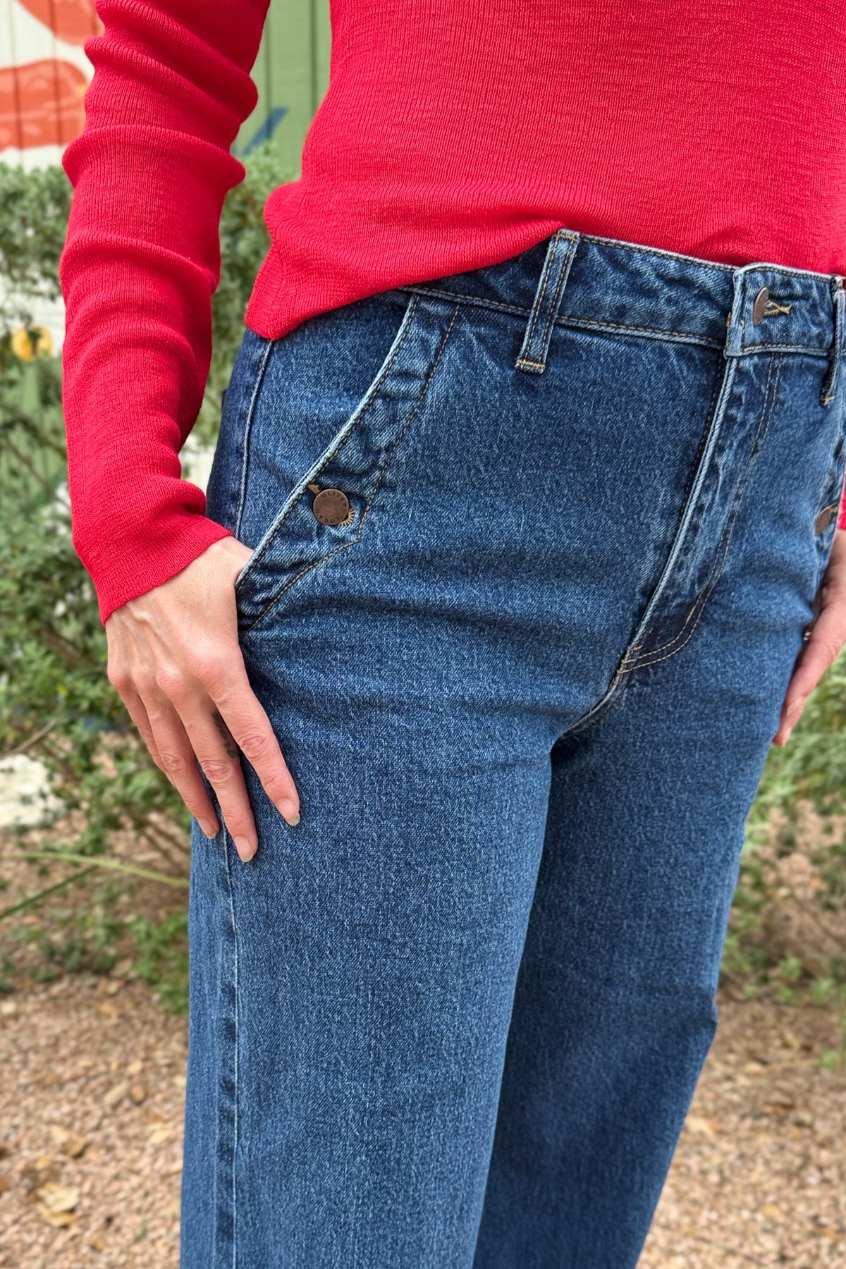 Women’s dark wash high rise wide leg jeans with button detail front pockets at Cotton & Cashmere in Blanco Texas