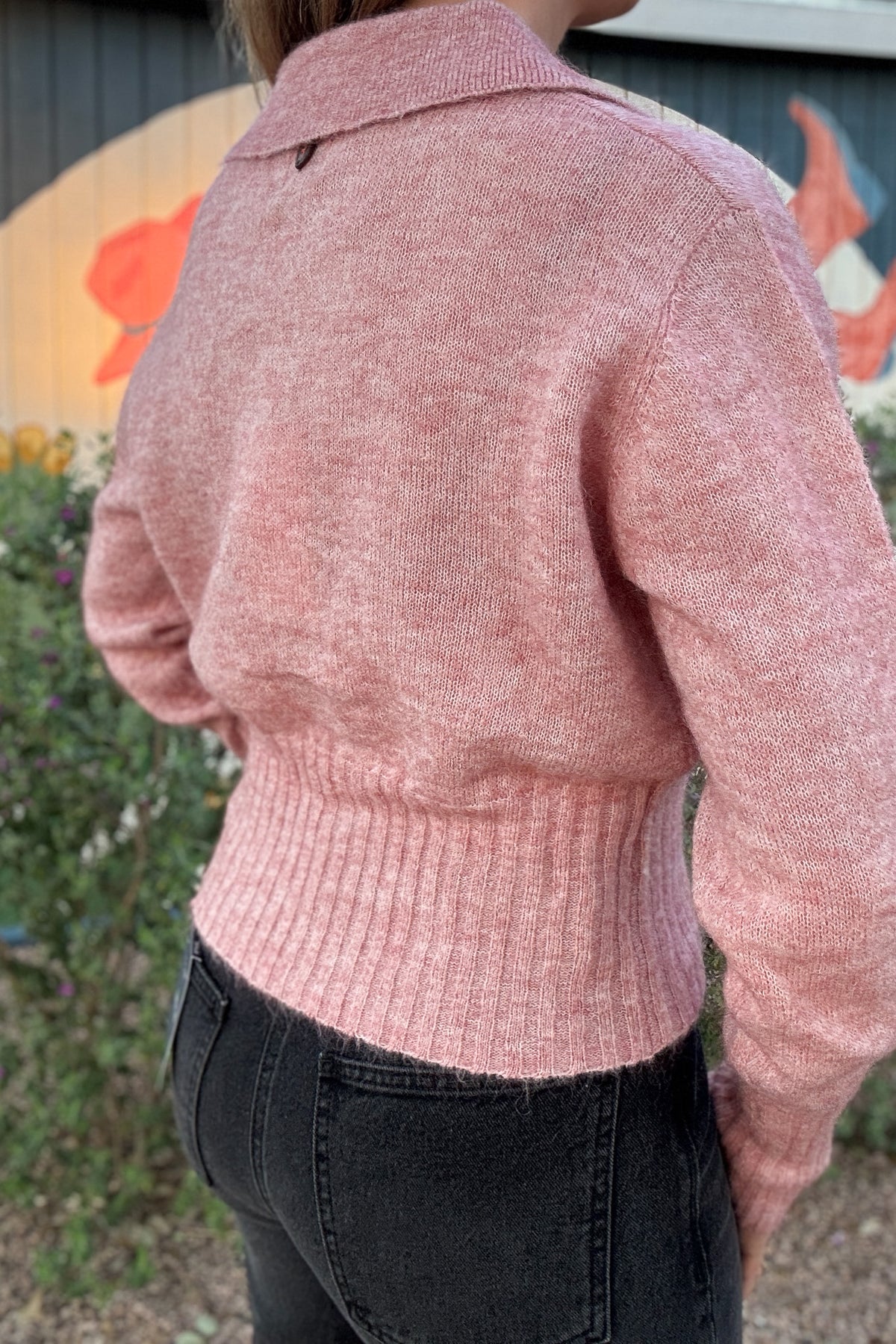 Casual pink polo sweater for women with a textured knit finish, open V-neck collar, and fitted ribbed waistband. Effortless everyday style from Cotton & Cashmere Boutique.