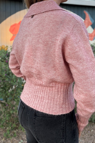 Casual pink polo sweater for women with a textured knit finish, open V-neck collar, and fitted ribbed waistband. Effortless everyday style from Cotton & Cashmere Boutique.