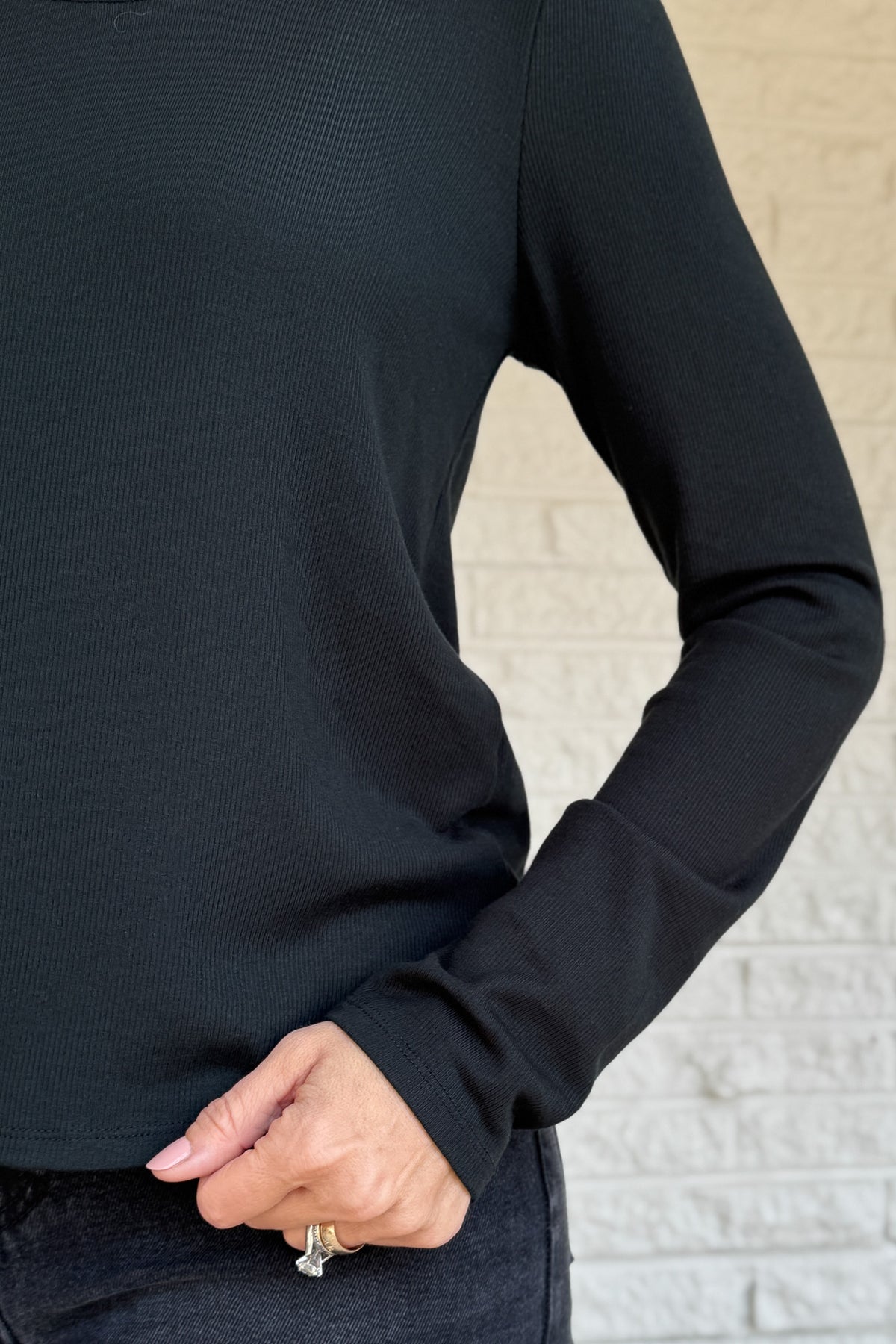 Sleek, soft, and effortlessly classic, this black long sleeve top is a true wardrobe essential. Crafted from silky micro modal with a hint of stretch, it offers a flattering drape and all-day comfort. Perfect for layering or wearing on its own with denim or trousers.