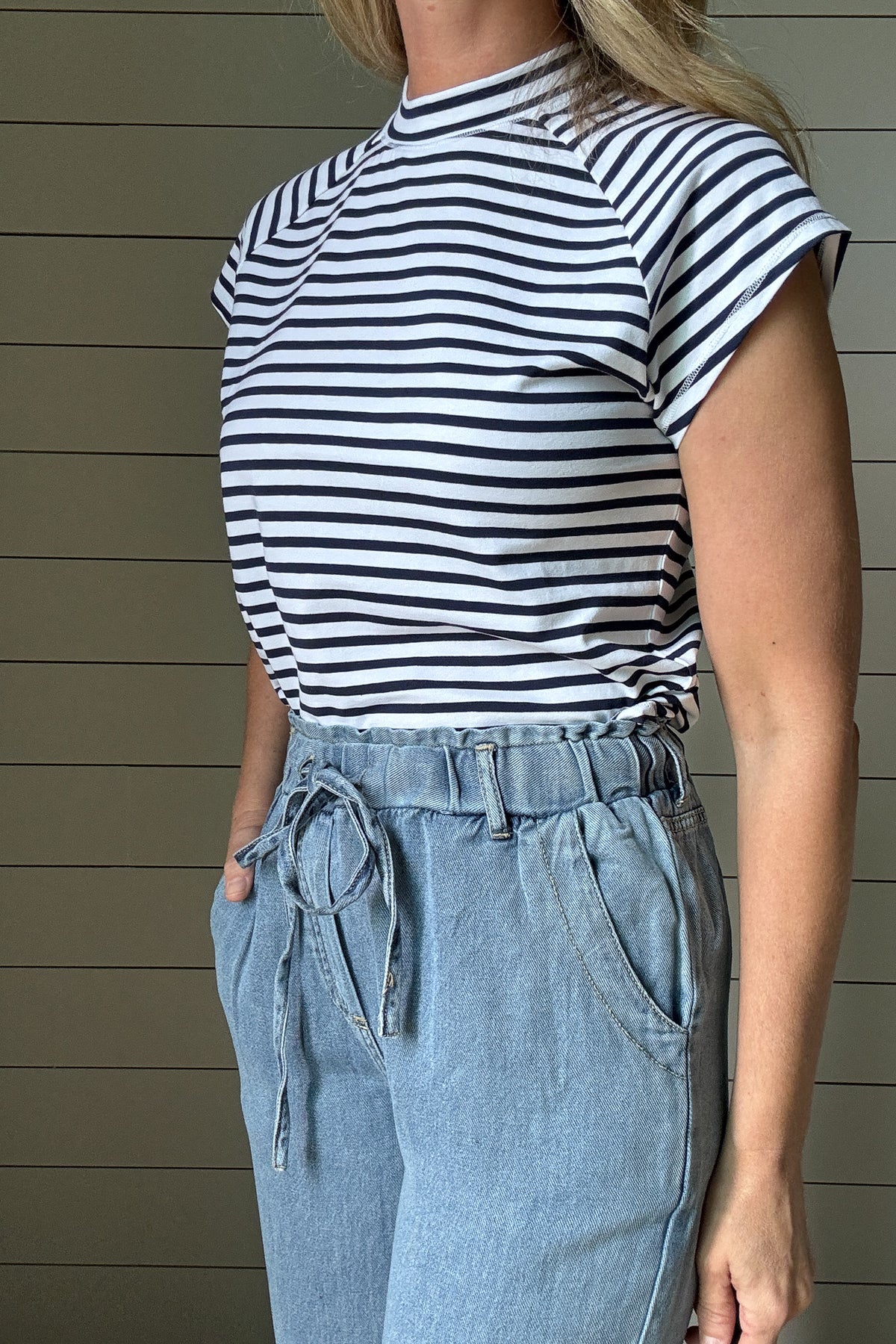 &nbsp;This striped high neck tee is a summer go-to. The navy and white stripe print feels fresh and classic, while the high neckline adds a modern touch. Made for everyday wear, it’s cut with a relaxed fit and a swooping hemline that gives it an easy, flattering shape. Whether you're heading out or staying casual, this tee is one you'll keep reaching for.