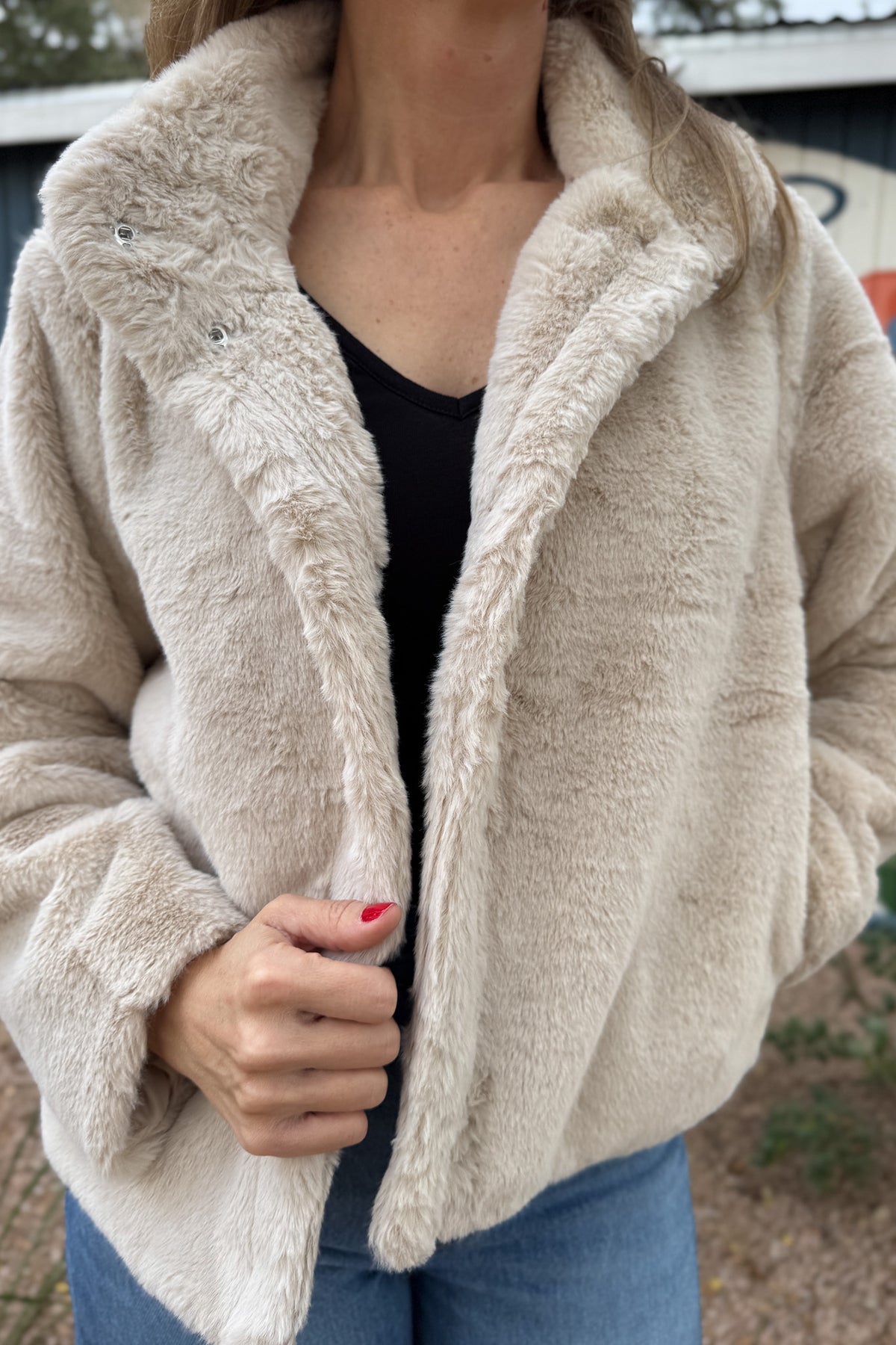 Soft, plush, and effortless to wear. This fully lined jacket brings the cozy factor without feeling bulky. The neutral tone pairs easily with denim or dresses, making it an easy grab when the weather turns cool. Finished with hidden side pockets and a snap-front neckline that can be worn open or folded up.