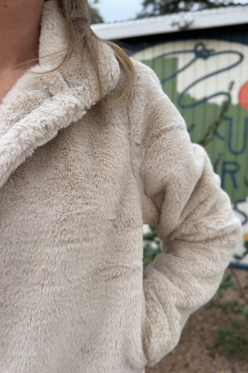 Soft, plush, and effortless to wear. This fully lined jacket brings the cozy factor without feeling bulky. The neutral tone pairs easily with denim or dresses, making it an easy grab when the weather turns cool. Finished with hidden side pockets and a snap-front neckline that can be worn open or folded up.