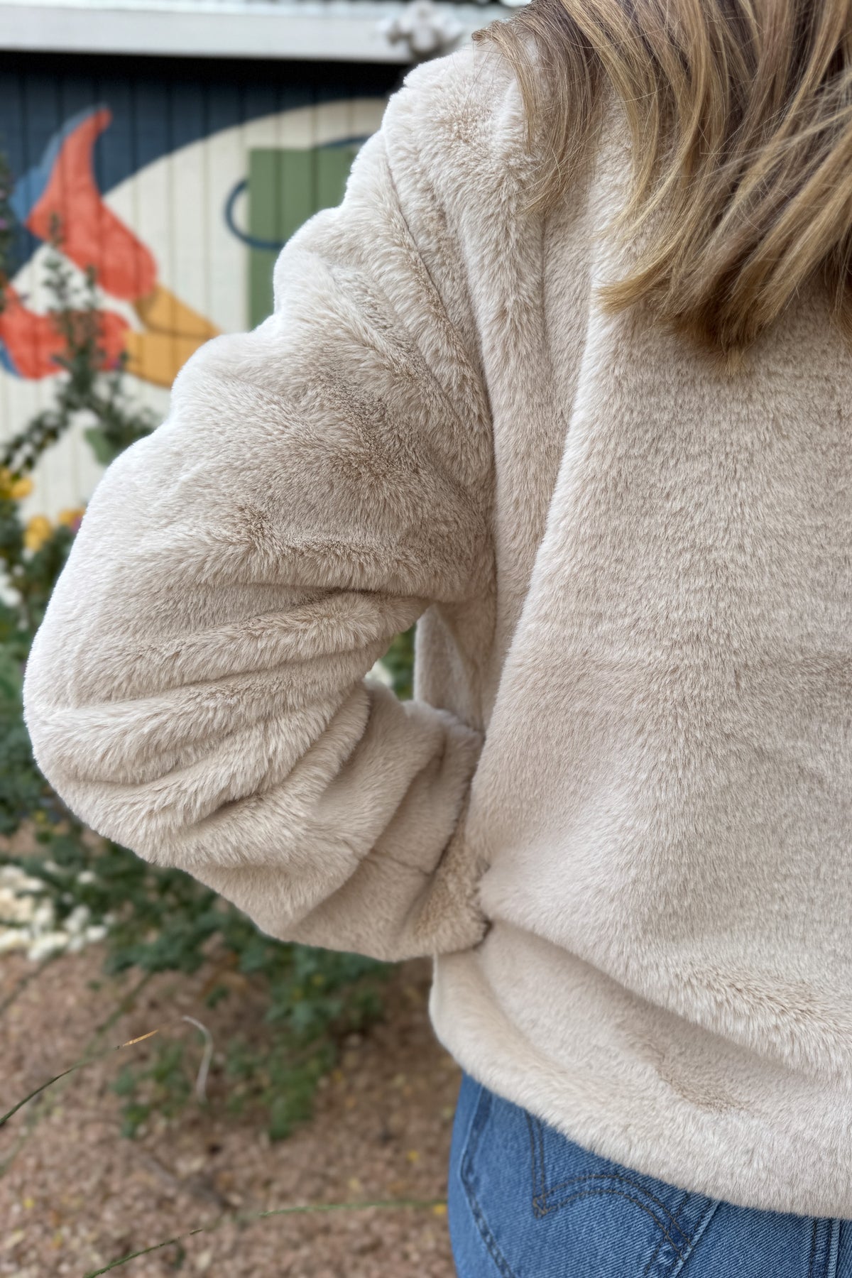 Soft, plush, and effortless to wear. This fully lined jacket brings the cozy factor without feeling bulky. The neutral tone pairs easily with denim or dresses, making it an easy grab when the weather turns cool. Finished with hidden side pockets and a snap-front neckline that can be worn open or folded up.