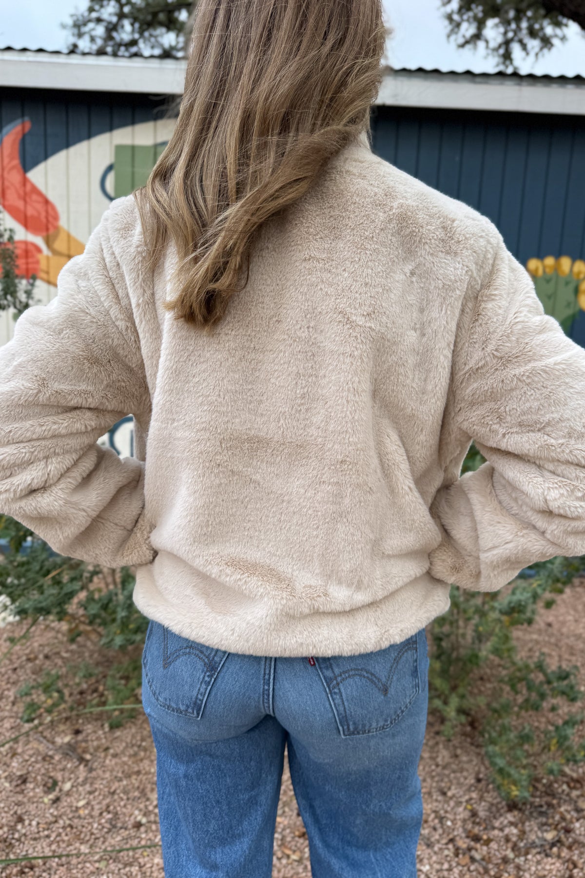 Soft, plush, and effortless to wear. This fully lined jacket brings the cozy factor without feeling bulky. The neutral tone pairs easily with denim or dresses, making it an easy grab when the weather turns cool. Finished with hidden side pockets and a snap-front neckline that can be worn open or folded up.