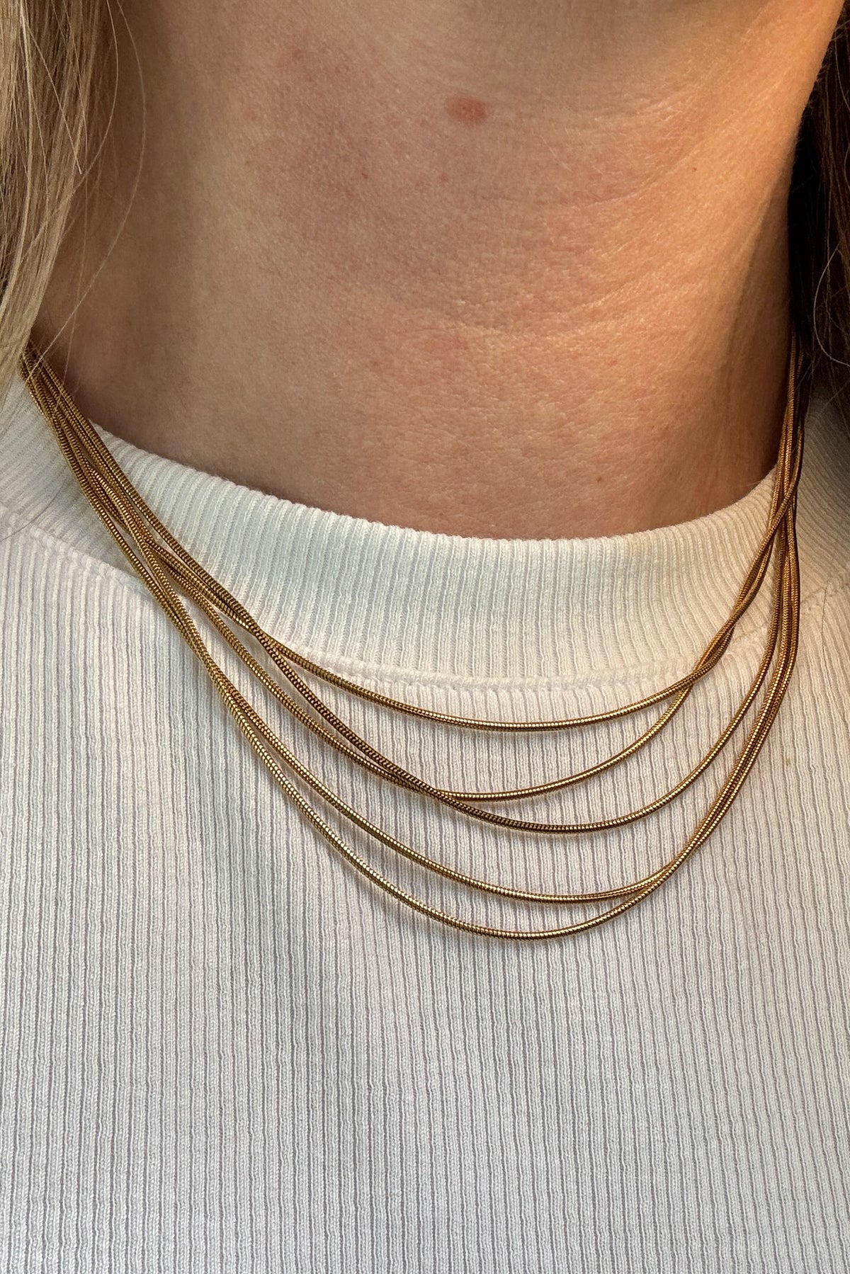 The string along necklace features five slim rope chains.&nbsp;

18k gold plated or stainless steel
water proof
adjustable 14.5" - 16.5"
nickel / lead free
made with materials ethically sourced