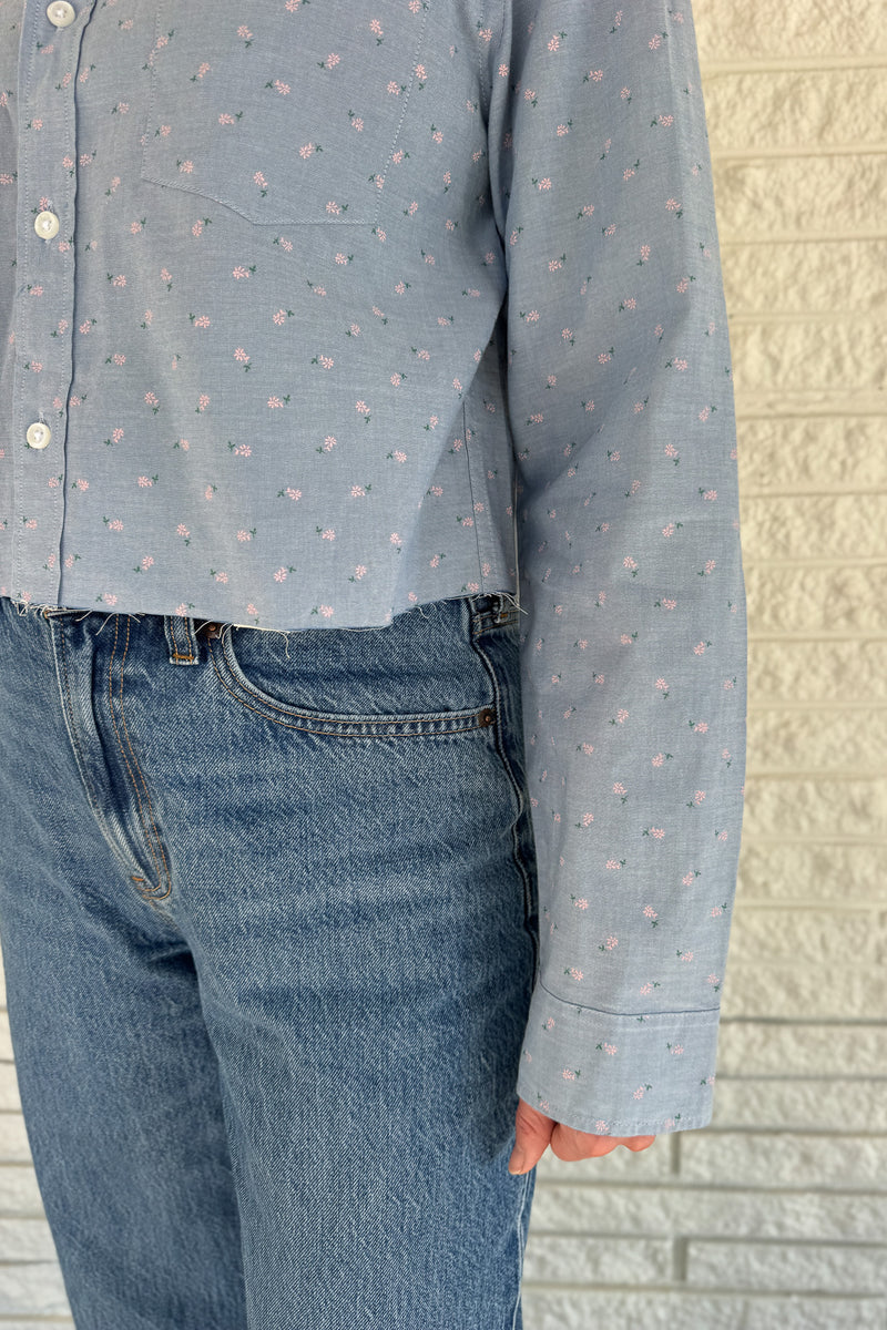 An upcycled men’s shirt reworked into a cropped, raw hem, easy silhouette that feels fresh and relaxed. Soft, feminine, and one-of-a-kind. Designed to be a one size fits most when worn open, wear it buttoned up and it fits like small or medium. Women's fashion boutique Blanco Texas Johnson City Texas