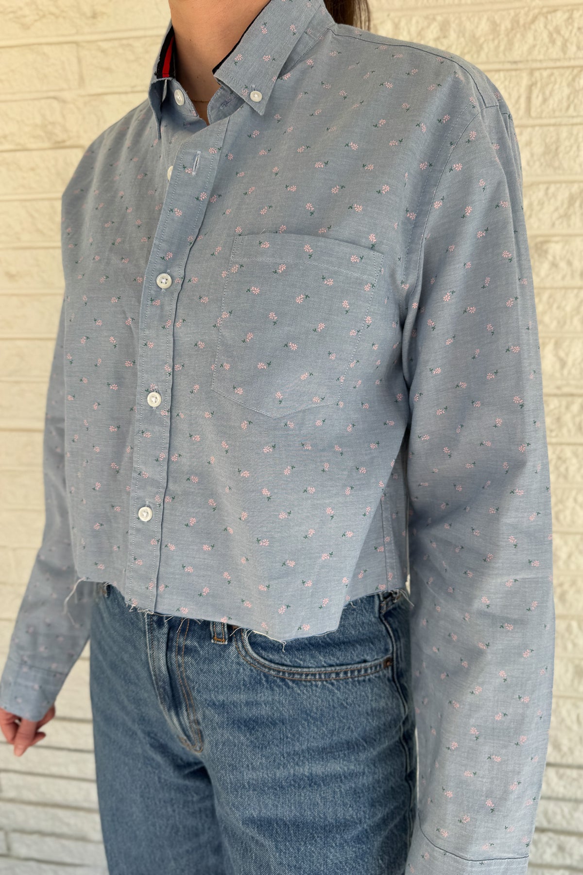 An upcycled men’s shirt reworked into a cropped, raw hem, easy silhouette that feels fresh and relaxed. Soft, feminine, and one-of-a-kind. Designed to be a one size fits most when worn open, wear it buttoned up and it fits like small or medium.