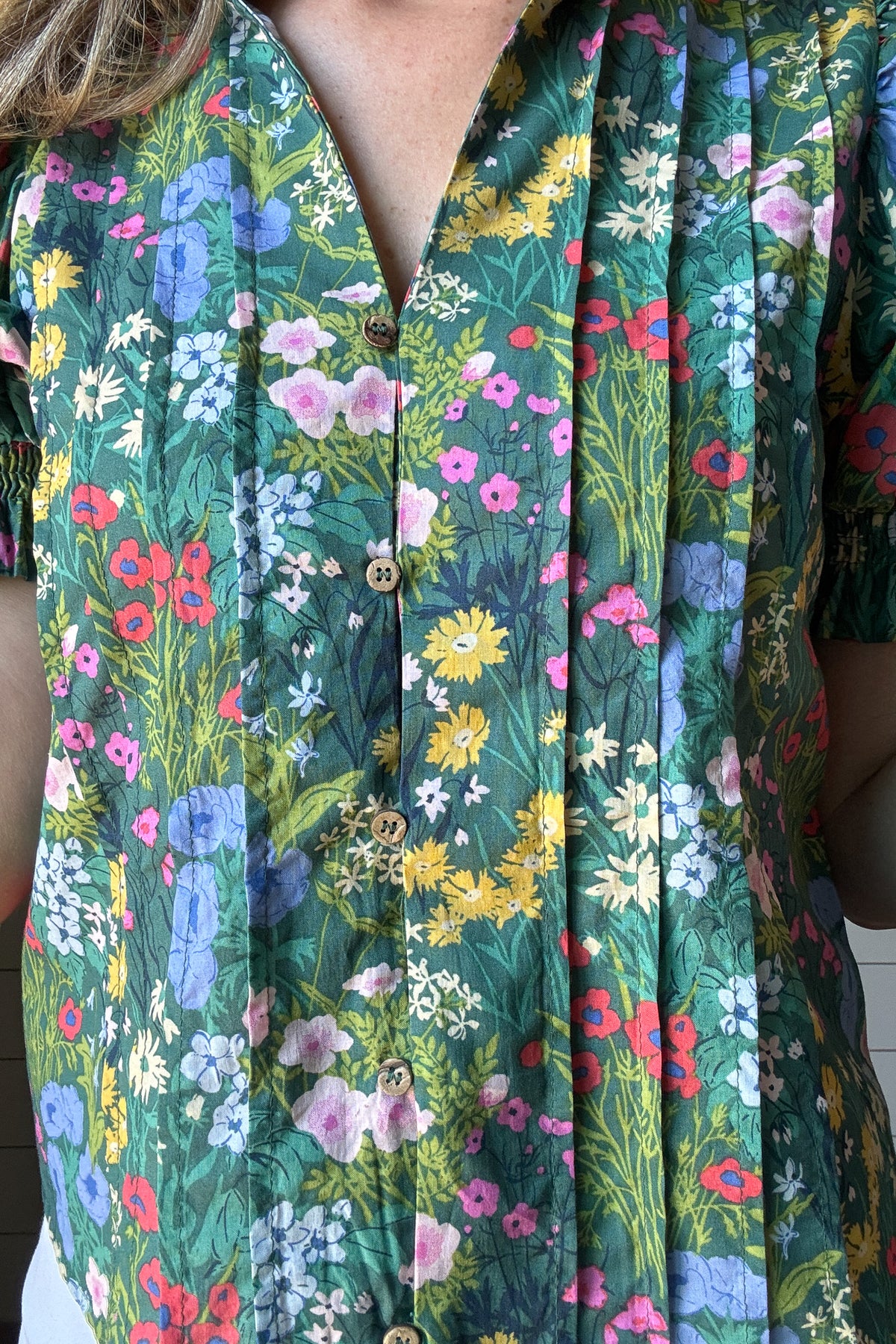 The Briar Floral Top is an easy pick for your everyday closet. Made from 100% cotton, it’s soft, breathable, and perfect for warm weather. The green floral print brings a fresh, feminine feel to this relaxed silhouette. Pin tuck detailing down the front adds subtle texture, while the smocked collar gives a soft, gathered touch around the neckline. It buttons all the way down the front with a placket overlay for extra coverage (none of us want gaping buttons!), making it easy to wear tucked or loose. Billowe