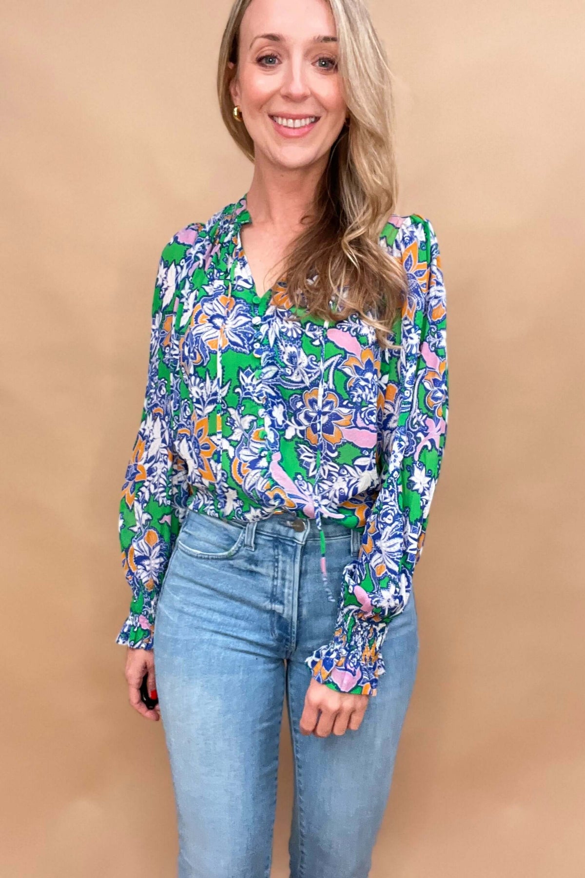 This lightweight and colorful fabric offers a playful twist with ruffled neckline and cuffs, tied neckline, and ever so slightly puffed shoulders.

The lightweight material is perfect for warmer days.&nbsp;

The fabric covered buttons, ruched detailing on the neckline &amp; cuffs adds an extra touch of elegance.