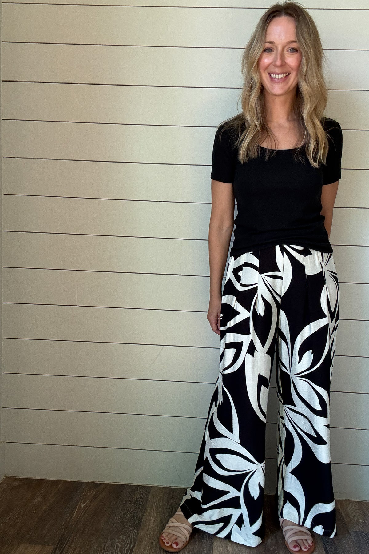 Effortless style meets all-day comfort in these wide-leg pants. Designed with a bold black-and-white abstract print, they’re the perfect statement piece for your everyday wardrobe. The elastic waist keeps the fit comfortable, while front pleats add shape and movement. Pair them with a simple tee or tank for a casual look, or dress them up with a chic blouse for a night out.