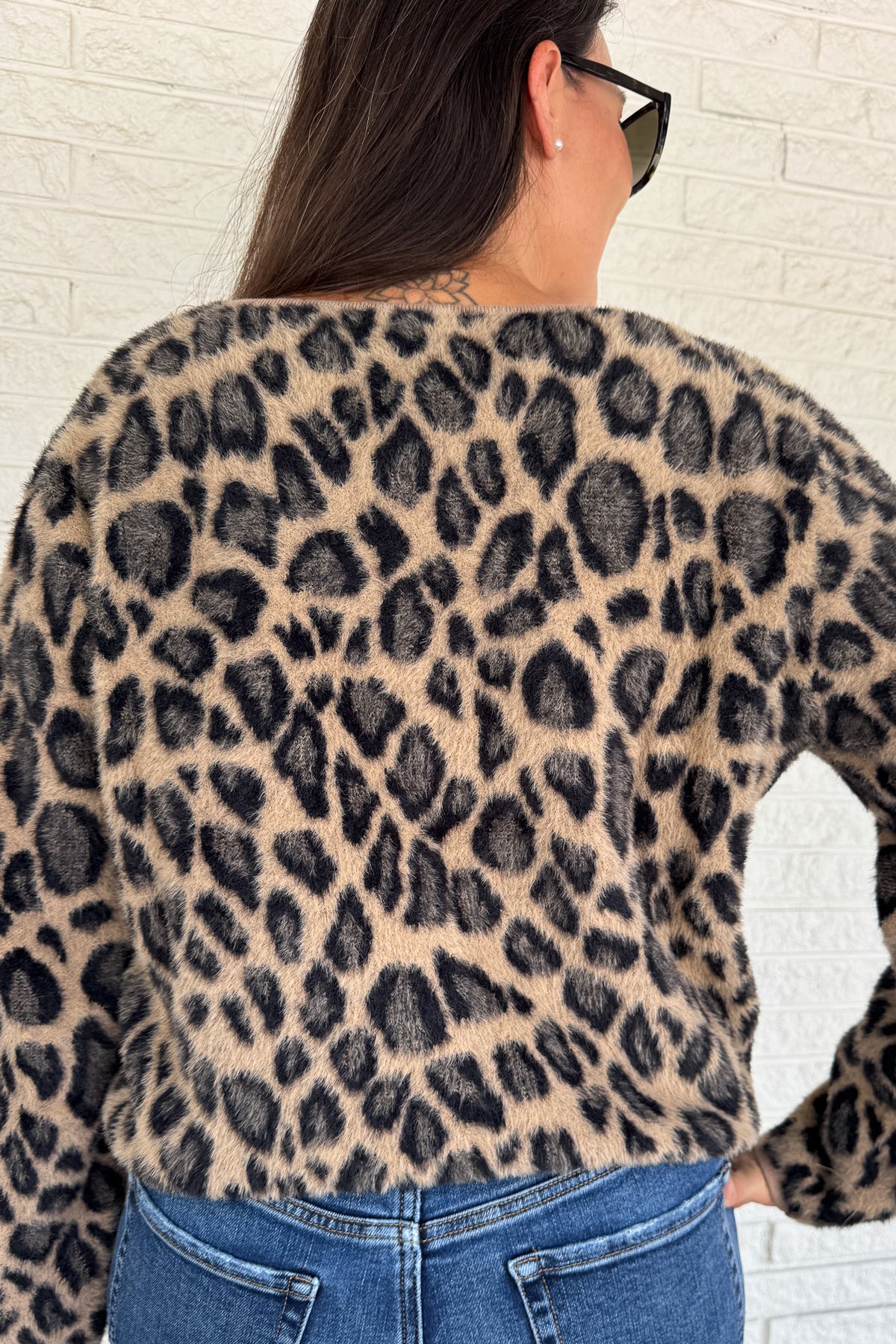 Add a playful pop to your wardrobe with this fuzzy leopard print cardigan. Made from a soft poly blend, it’s cozy with a touch of fun, featuring a button front, front pockets, and a cropped fit. A statement layer that still feels effortless for everyday wear.