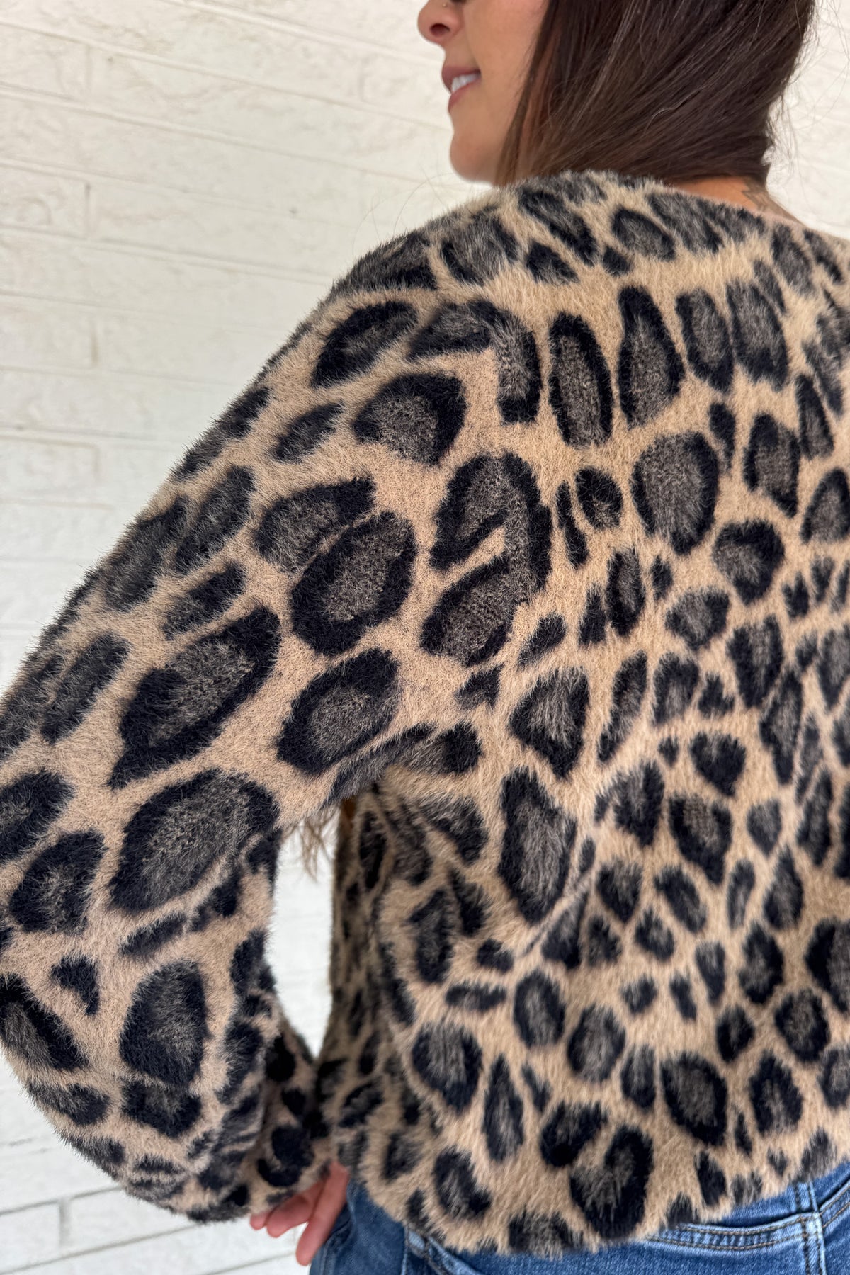 Add a playful pop to your wardrobe with this fuzzy leopard print cardigan. Made from a soft poly blend, it’s cozy with a touch of fun, featuring a button front, front pockets, and a cropped fit. A statement layer that still feels effortless for everyday wear.