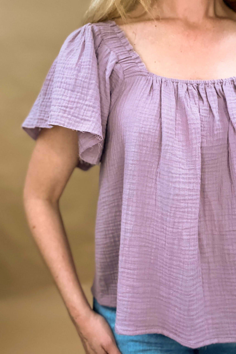 gauze lavender top raw cut sleeve, elastic at shoulders and chest 