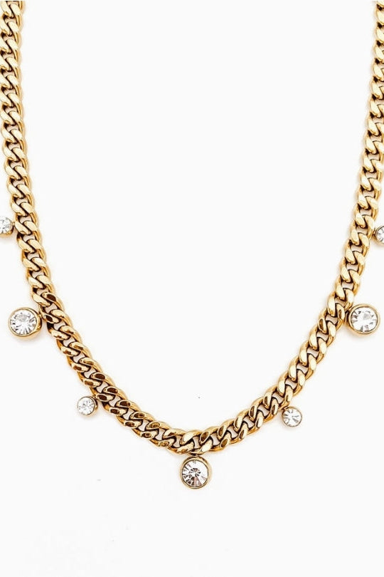 Gold chain necklace with small diamonds on a white background
