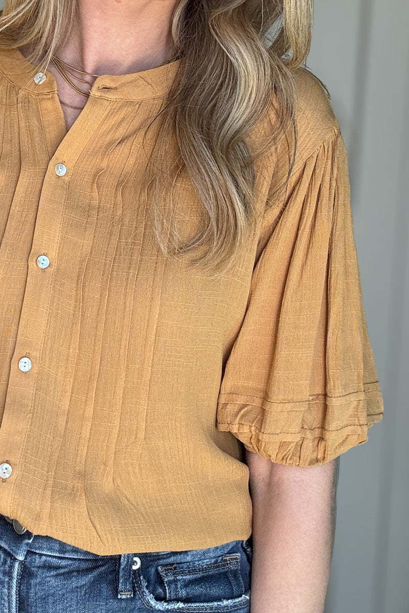 Stay golden in our Goldrod Blouse! This lightweight, button-front top features pin tuck detailing and elastic yellow sleeves for a playful touch. Whether tucked in or untucked, this Goldenrod top will give you that effortless, slightly below look.