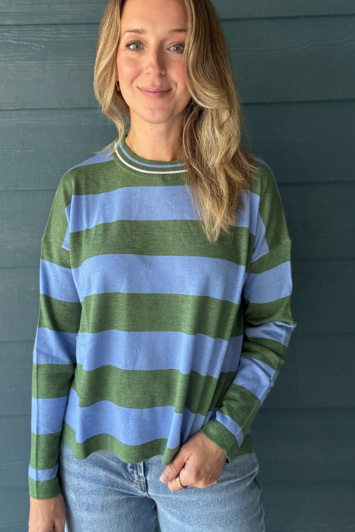 Women’s green and blue striped knit sweater with long sleeves, relaxed fit and contrast ribbed neckline at Cotton & Cashmere boutique in Blanco, Texas.