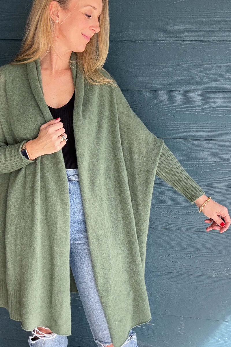 A cold weather must, this 100% cashmere long line cardigan fits snuggly on the forearms and cocoons out for a cozy &amp; flowy fit.

It is loose &amp; easy which makes a perfect layering piece.