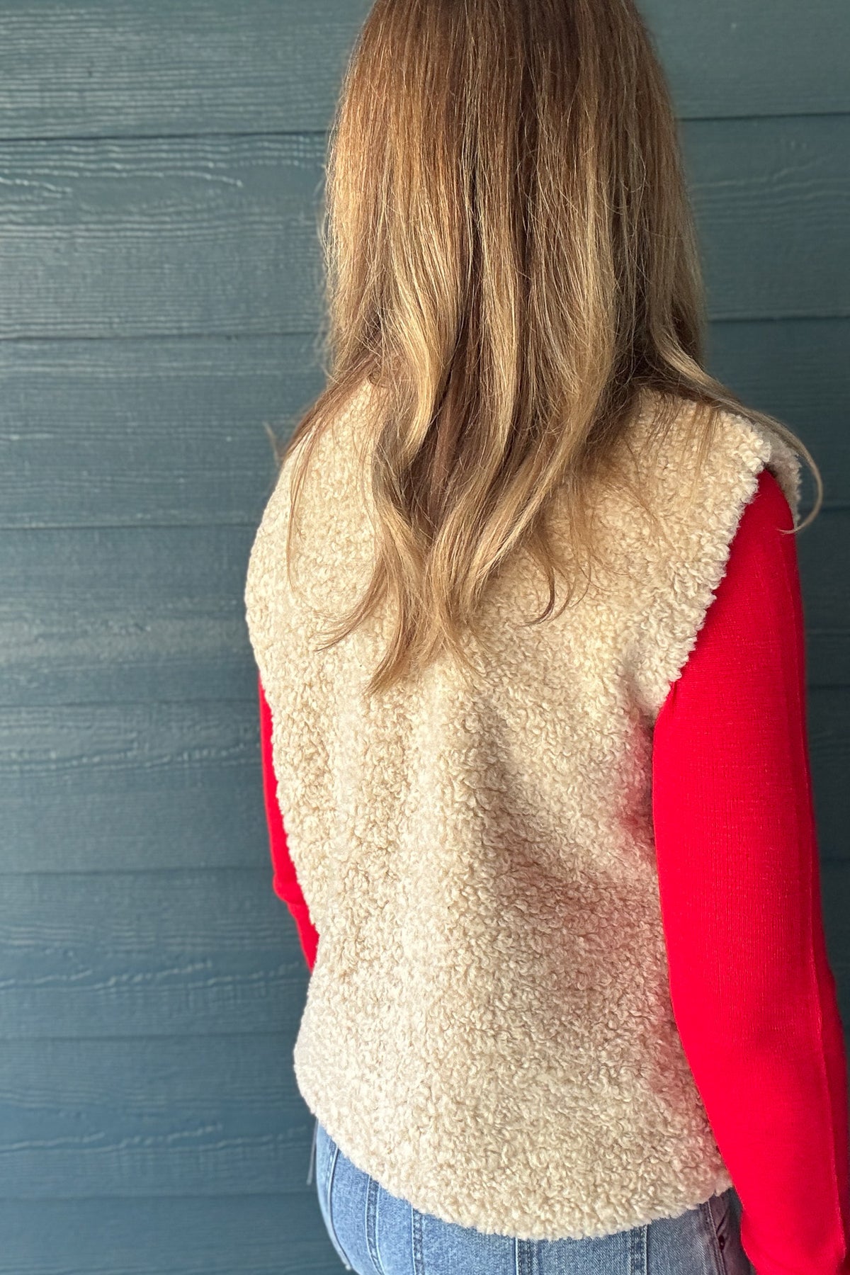 Back view of women’s cream faux sherpa vest by Habitual Denim with relaxed fit and soft textured finish.
