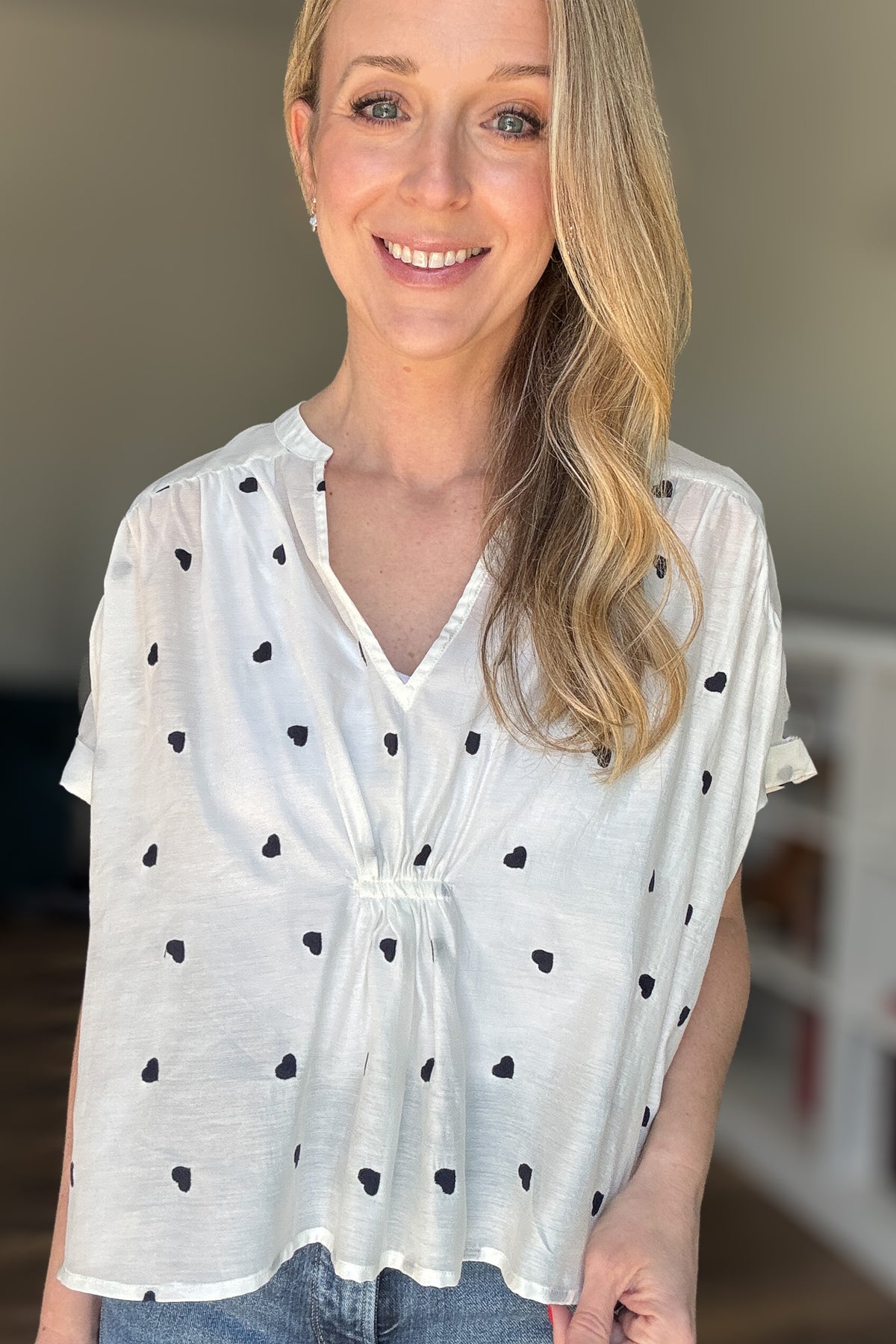 Meet your new favorite blouse! This lightweight white cotton blouse from Traffic People is effortlessly chic with its loose, roomy fit and delicate navy-blue embroidered hearts. Slightly sheer for an airy feel, layer with a tank for extra coverage or embrace its breezy nature. Perfect for pairing with denim or linen for an easy, polished look.