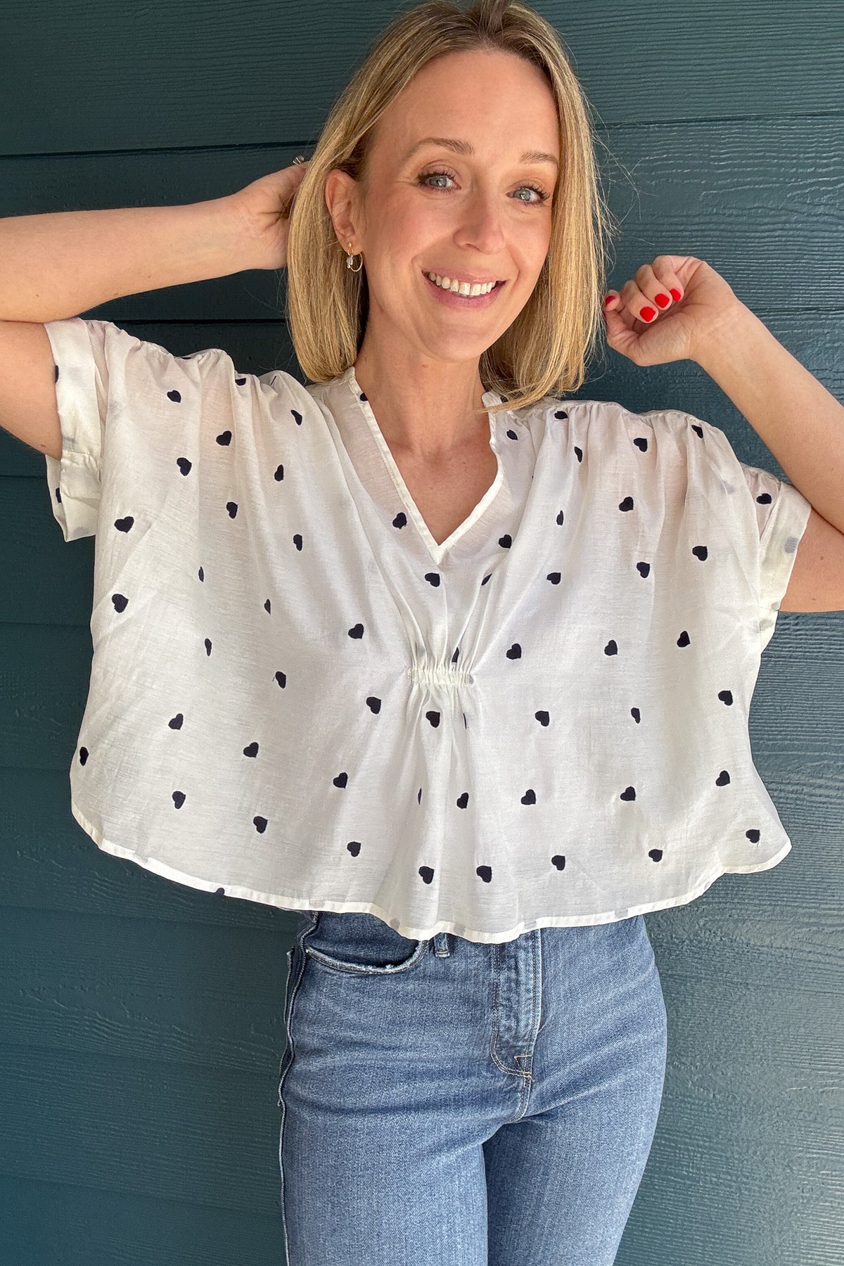 Meet your new favorite blouse! This lightweight white cotton blouse from Traffic People is effortlessly chic with its loose, roomy fit and delicate navy-blue embroidered hearts. Slightly sheer for an airy feel, layer with a tank for extra coverage or embrace its breezy nature. Perfect for pairing with denim or linen for an easy, polished look.