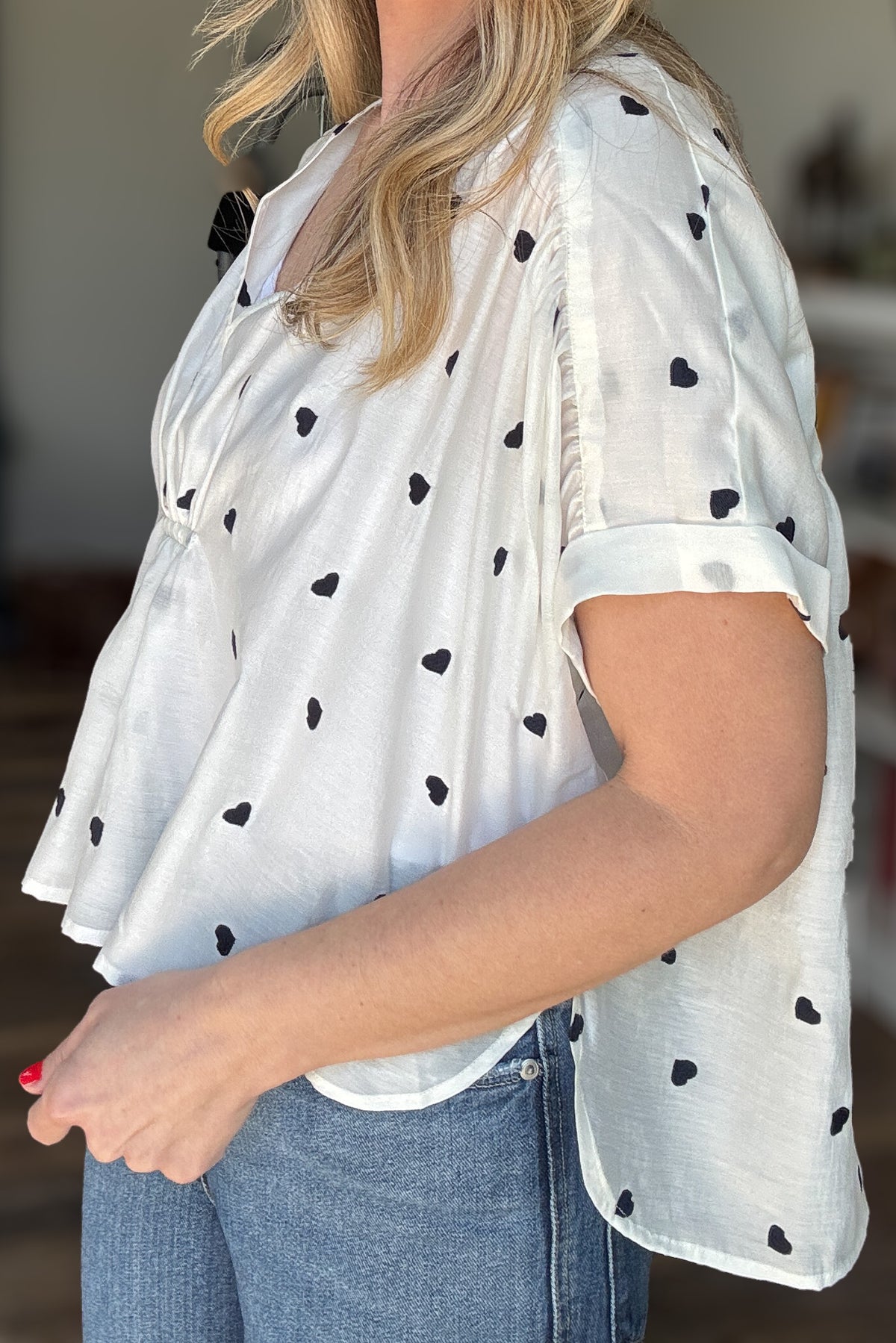 Meet your new favorite blouse! This lightweight white cotton blouse from Traffic People is effortlessly chic with its loose, roomy fit and delicate navy-blue embroidered hearts. Slightly sheer for an airy feel, layer with a tank for extra coverage or embrace its breezy nature. Perfect for pairing with denim or linen for an easy, polished look.