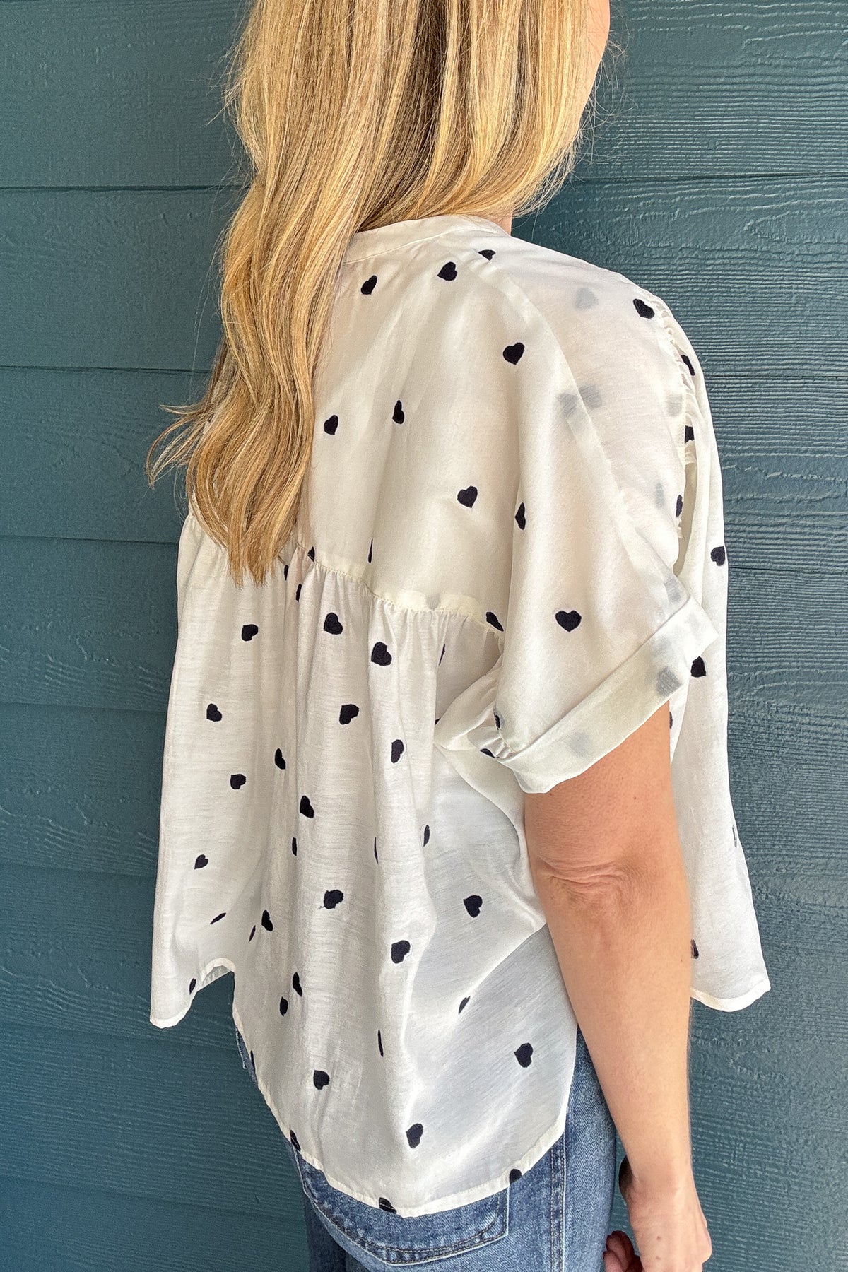 Meet your new favorite blouse! This lightweight white cotton blouse from Traffic People is effortlessly chic with its loose, roomy fit and delicate navy-blue embroidered hearts. Slightly sheer for an airy feel, layer with a tank for extra coverage or embrace its breezy nature. Perfect for pairing with denim or linen for an easy, polished look.